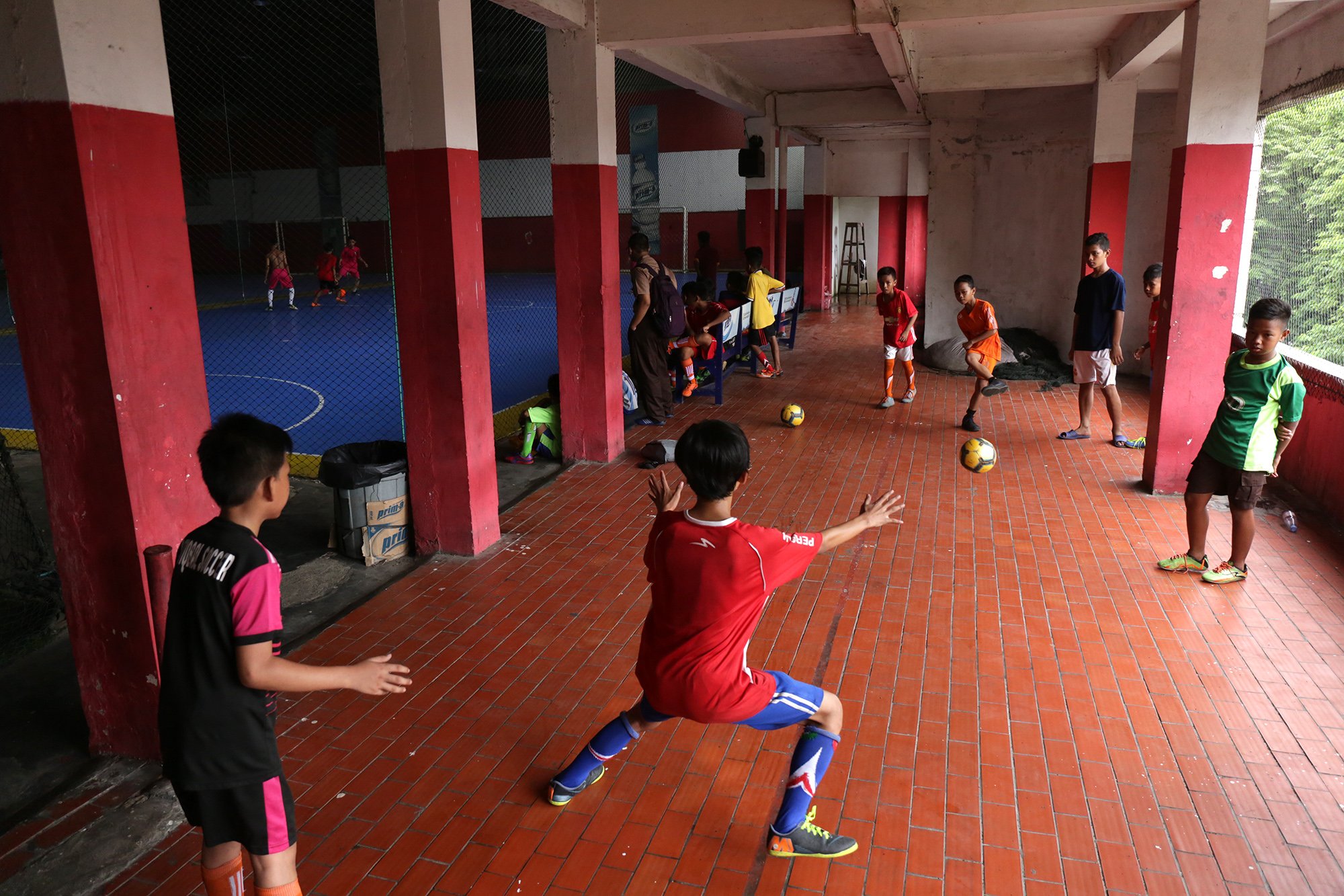 Sejumlah anak laki-laki bermain futsal di Futsal Rakyat, Psar Grogol, Jakarta Barat (12/12). Para warga tidak hanya menggunakan pasar sebagai tempat belanja. 