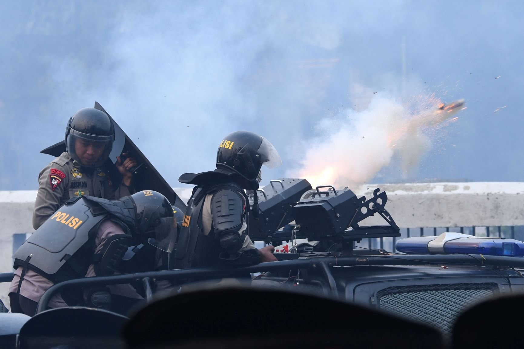 Polisi melontarkan gas air mata saat kericuhan dalam unjuk rasa di depan kompleks Parlemen di Jakarta, Selasa (24/9/2019). Ribuan mahasiswa yang berasal dari kampus di sejumlah daerah itu turun ke jalan berdemonstrasi menolak UU KPK dan pengesahan RUU KUHP. 