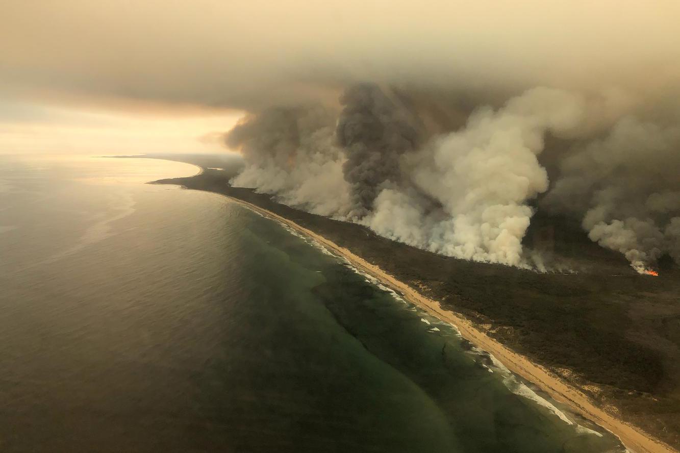 Gumpalan asap tebal meninggi dari kebakaran di pantai East Gippsland, Victoria, Australia, Sabtu (4/1/2020), dalam foto udara yang diambil dari pesawt jet AMSA Challenger.