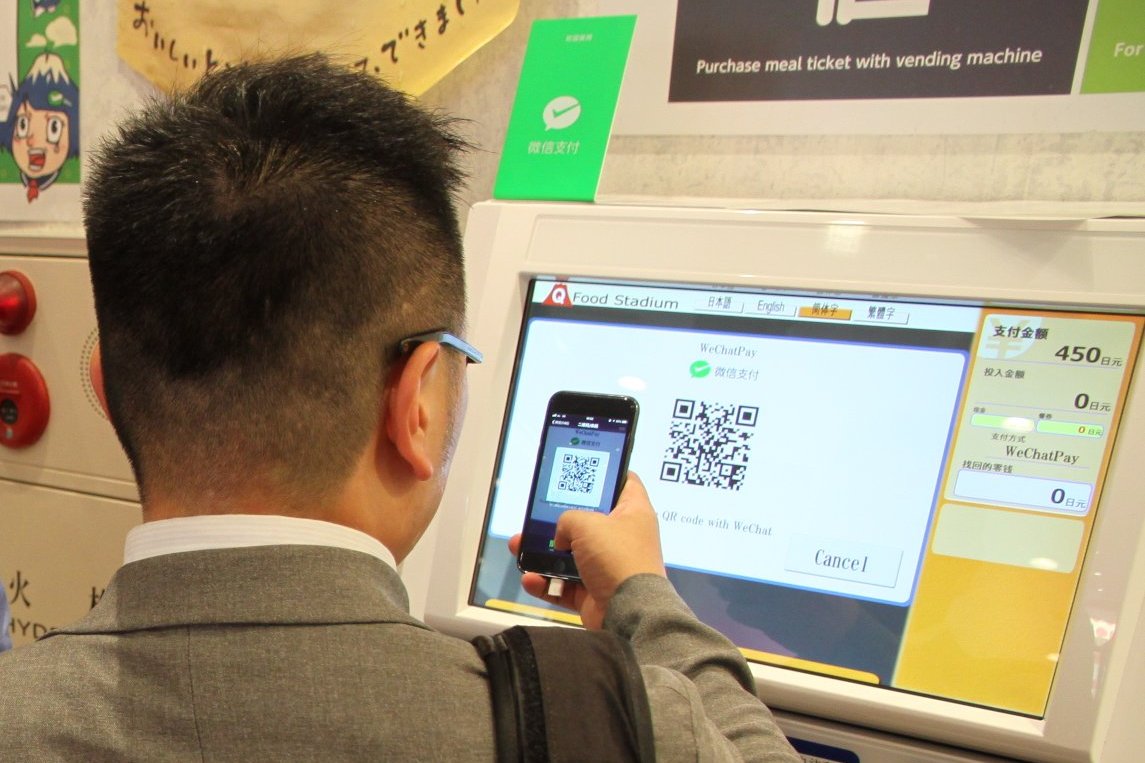 Seorang konsumen memindai kode QR untuk pembayaran WeChatPay di Tiongkok.