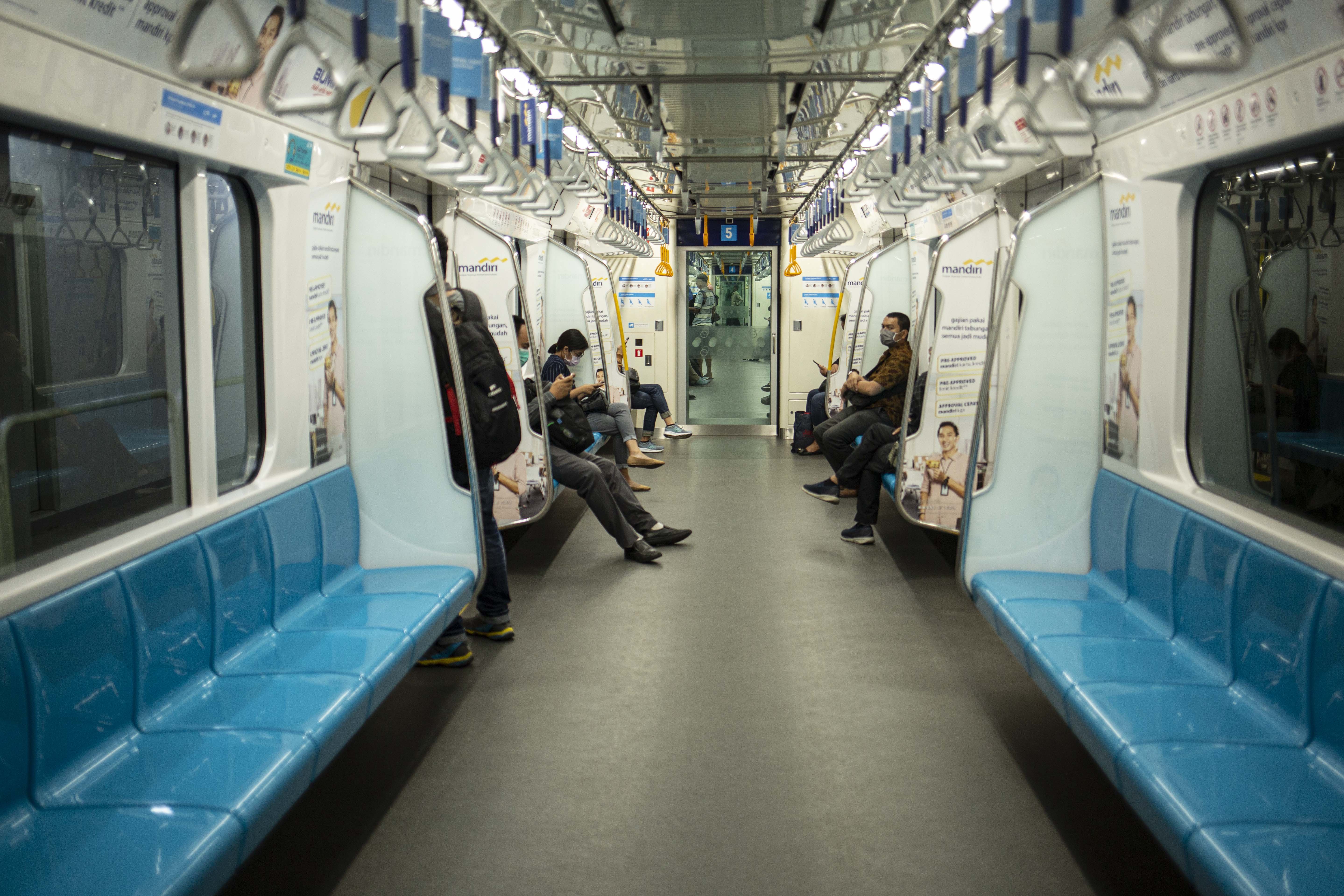 Warga menaiki MRT di Stasiun Bunderan HI. MRT membatasi waktu oprasional dan jumlah penumpang satu gerbongnya.
