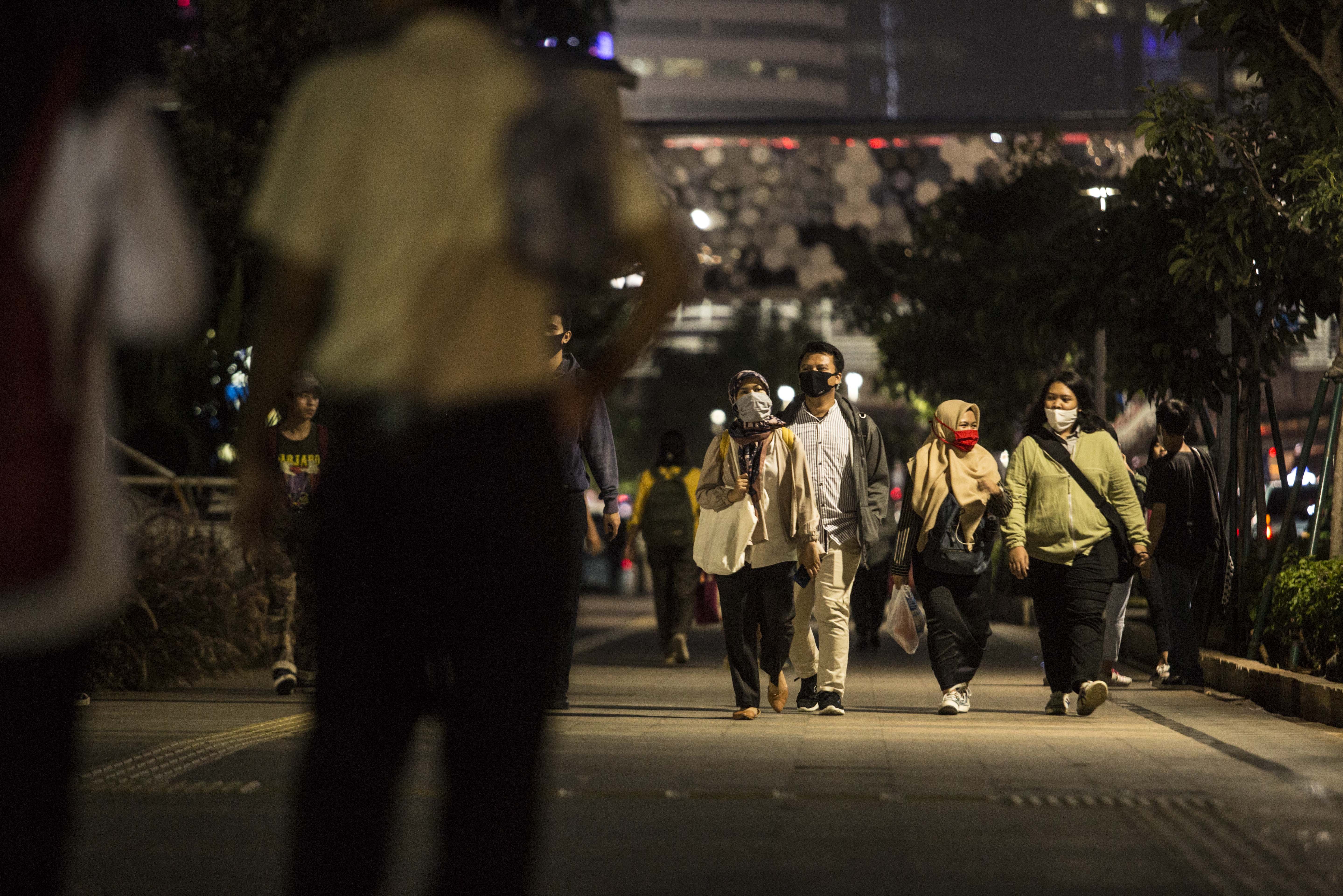 Sejumlah pekerja berjalan di Trotoal Jalan Sudirman, Jakarta Pusat, Senin (8/6/2020),