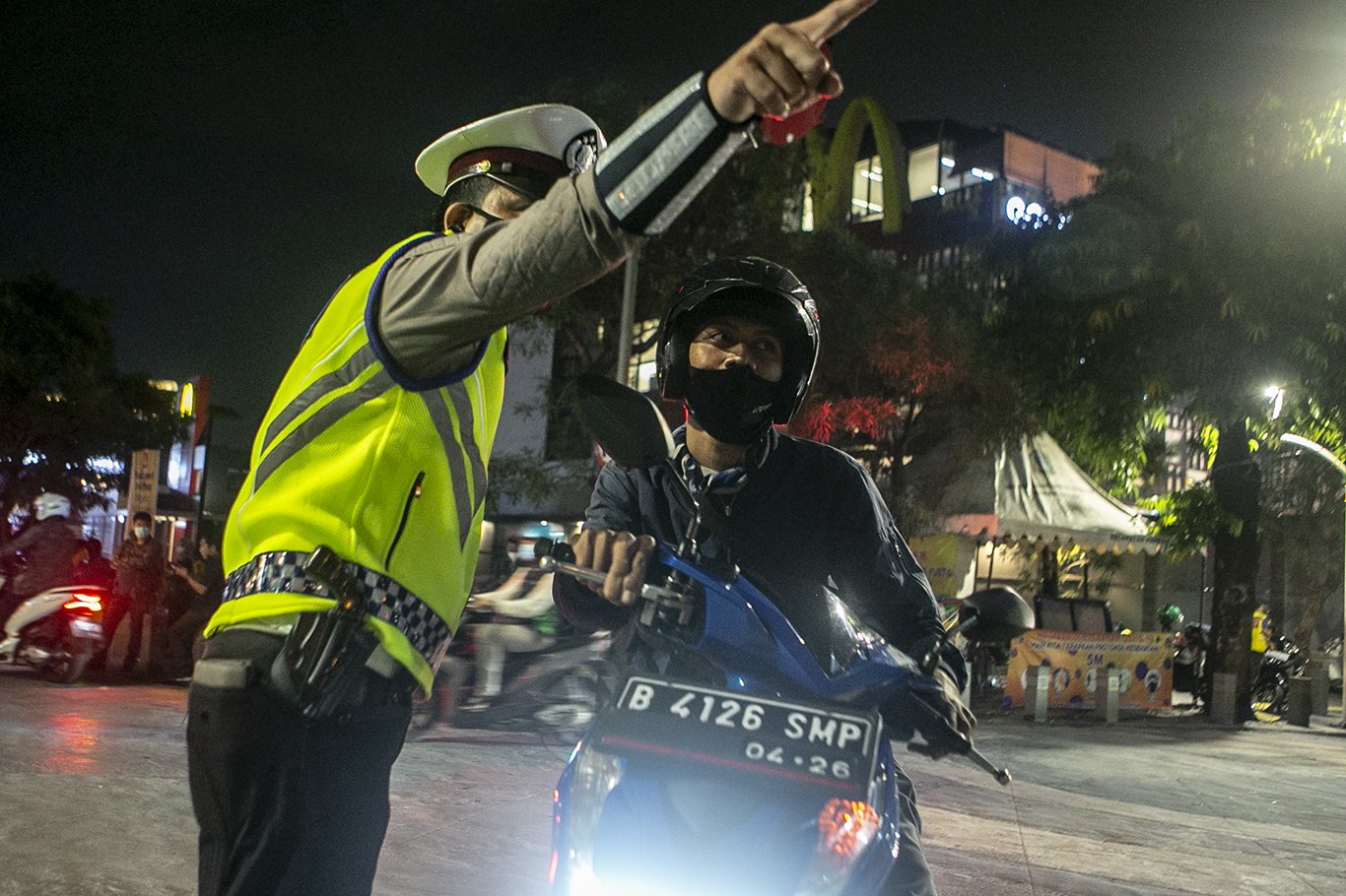 Petugas kepolisian mengarahkan pengendara untuk memutar balik saat melakukan penutupan jalan dalam rangka pembatasan mobilitas warga guna menekan penyebaran COVID-19 di kawasan Kemang, Jakarta, Senin (21/6/2021). Pembatasan tersebut dilakukan mulai pukul 21.00 WIB hingga 04.00 WIB di 10 titik di Kota Jakarta diantaranya Jalan Cikini Raya, kawasan Jalan Sabang, kawasan BKT, kawasan Kemang, PIK 2, kawasan Kota Tua dan Bulungan.