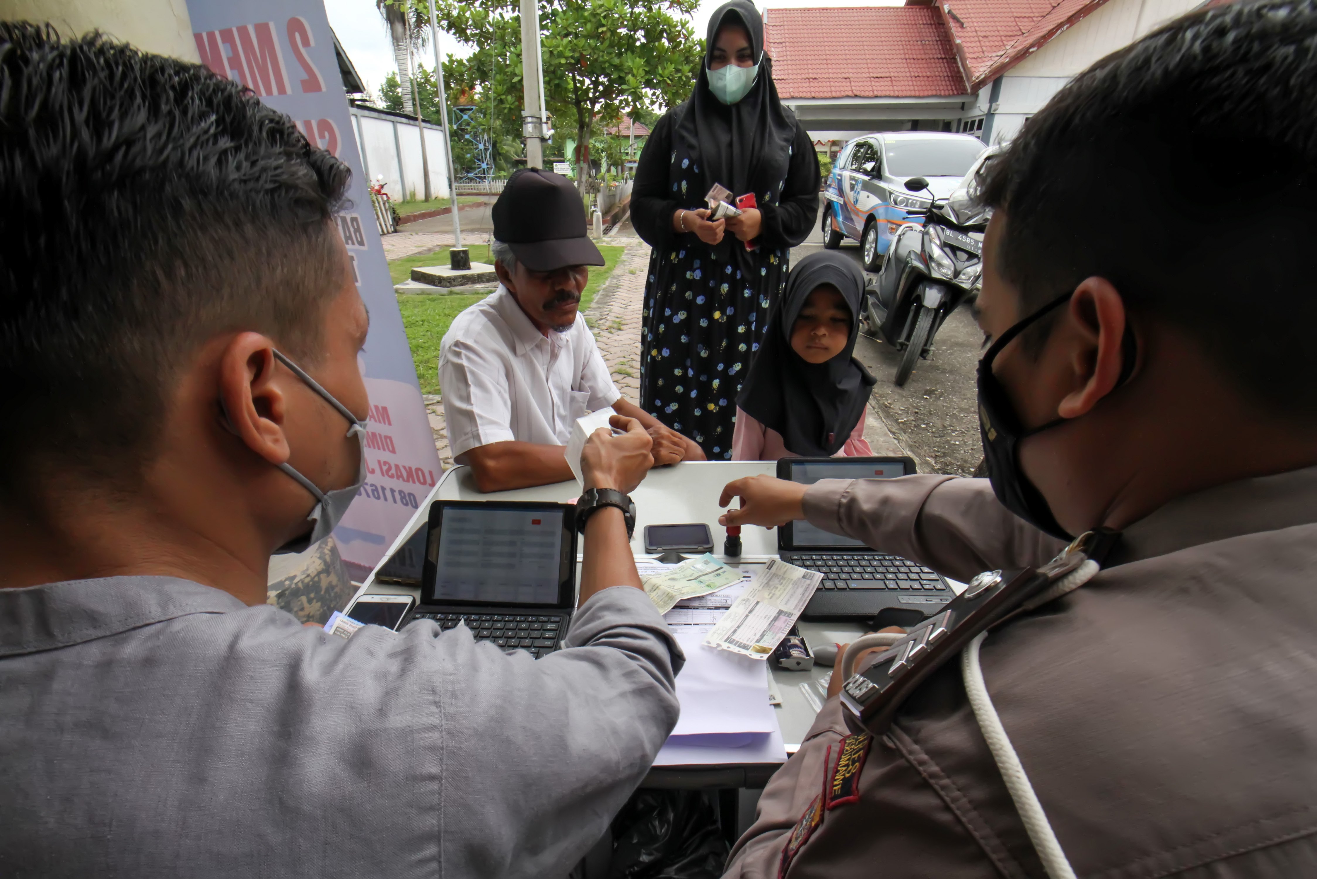 Petugas melayani warga yang akan melakukan pelunasan kewajiban pajak kendaraan secara daring melalui sepeda motor Sijempol di Kecamatan Blang Mangat, Lhoksumawe, Aceh.