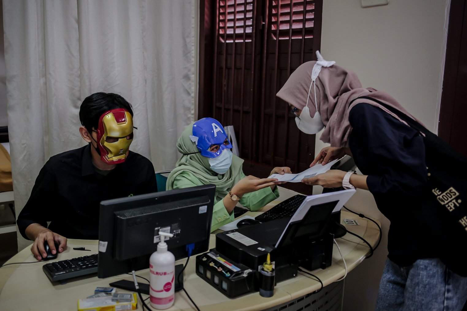 Petugas Kesehatan menegakan topeng super hero melakukan registrasi sebelum menyuntikkan vaksin covid-19 untuk anak-anak usia 6-11 tahun di Rumah Sakit Ibu dan Anak (RSIA) Tambak, Jakarta, Rabu (22/12/2021). Upaya tersebut dilakukan pihak rumah sakit untuk menarik minat anak-anak mengikuti vaksinasi Covid-19.