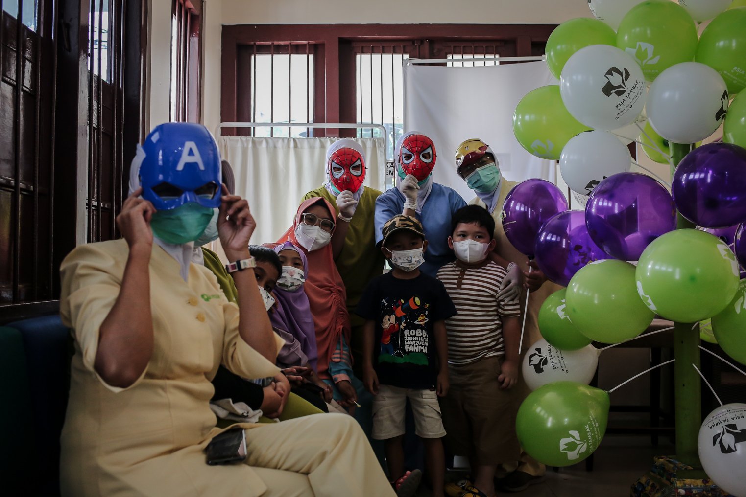 Petugas Kesehatan menegakan topeng super hero berswafoto dengan anak-anak setelah menyuntikkan vaksin covid-19 untuk anak-anak usia 6-11 tahun di Rumah Sakit Ibu dan Anak (RSIA) Tambak, Jakarta, Rabu (22/12/2021). Upaya tersebut dilakukan pihak rumah sakit untuk menarik minat anak-anak mengikuti vaksinasi Covid-19.