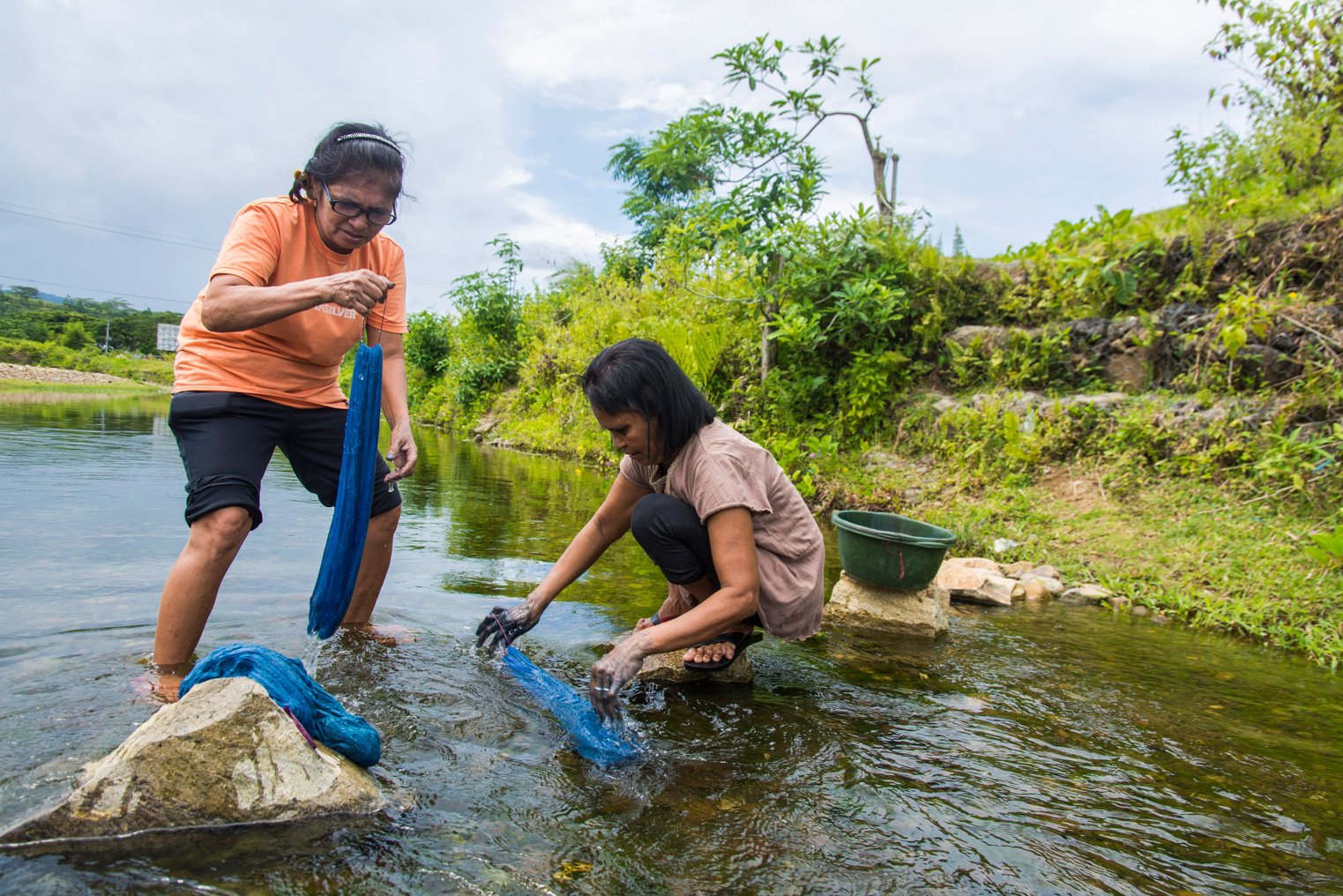 Anggota kelompok Ralsasam mencuci kain yang telah diberi pewarna berbahan dasar daun taro yang digunakan sebagai pewarna alami kain tenun ikat Tanimbar, Ambon, Maluku. ANTARA FOTO/ FB Anggoro/AW.
