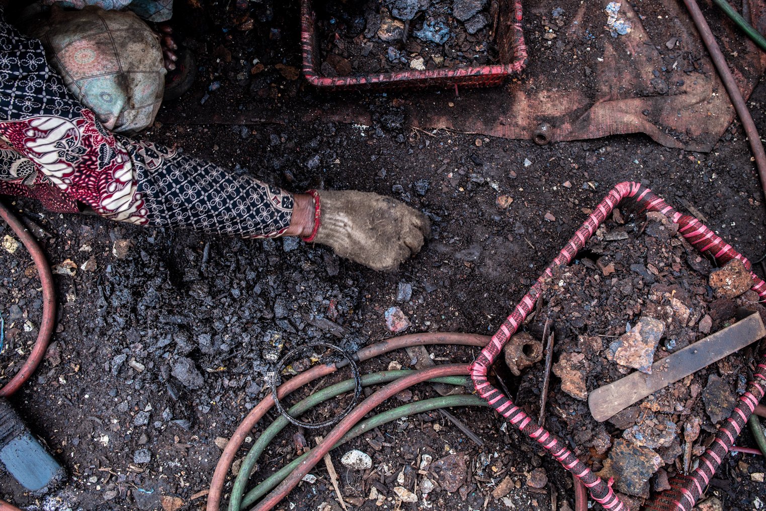 Pencari besi karat mengambil besi karat yang terjatuh di tanah di kawasan Belah Kapal, Cilincing, Jakarta Utara.