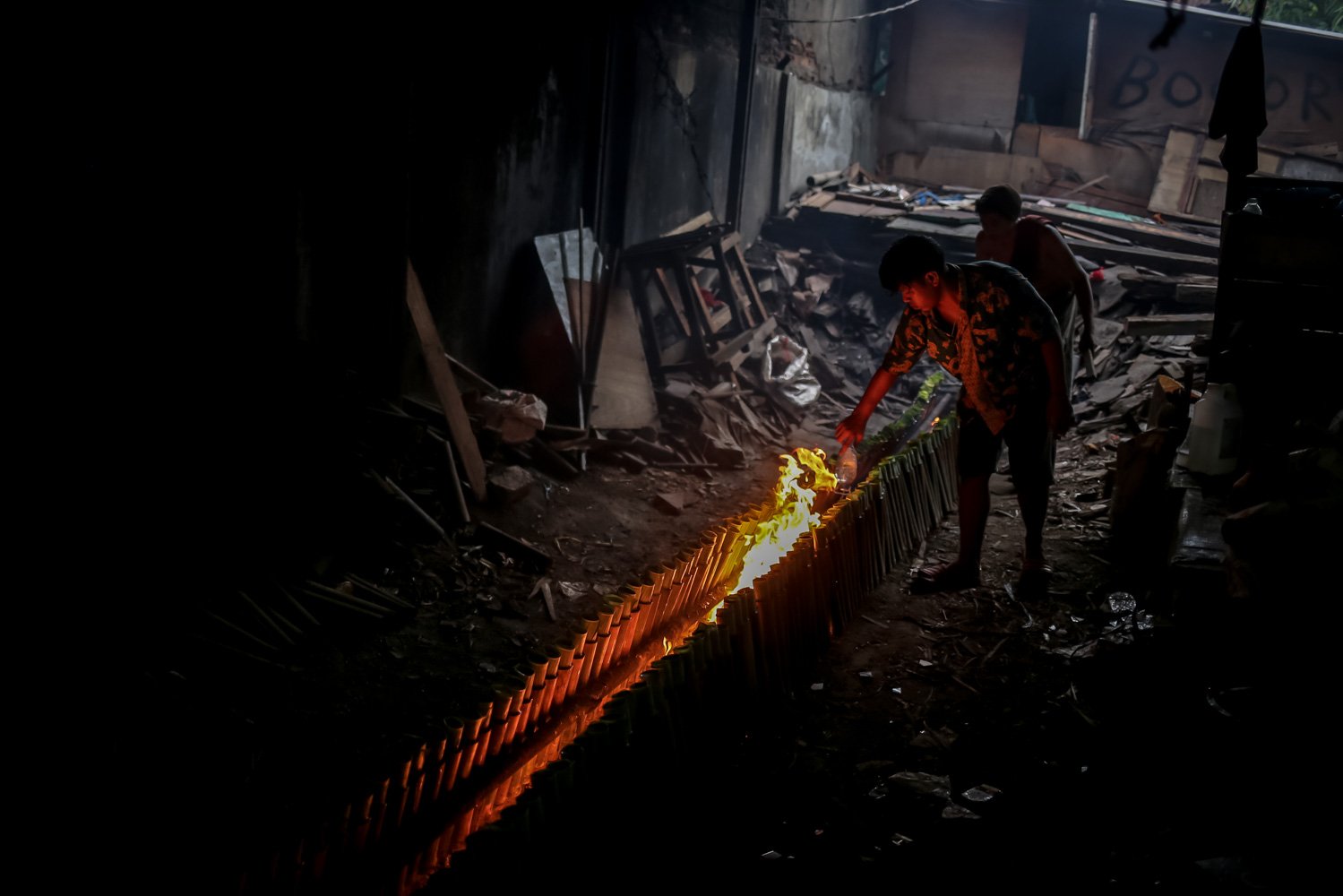 Pekerja menyelesaikan proses pembakaran lemang tapai di kawasan Senen, Jakarta, Selasa (28/3). Selama bulan Ramadhan, pelaku usaha lemang tapai meningkatkan produksi hingga 300 buah per hari dengan harga jual sebesar Rp17 ribu per batang.