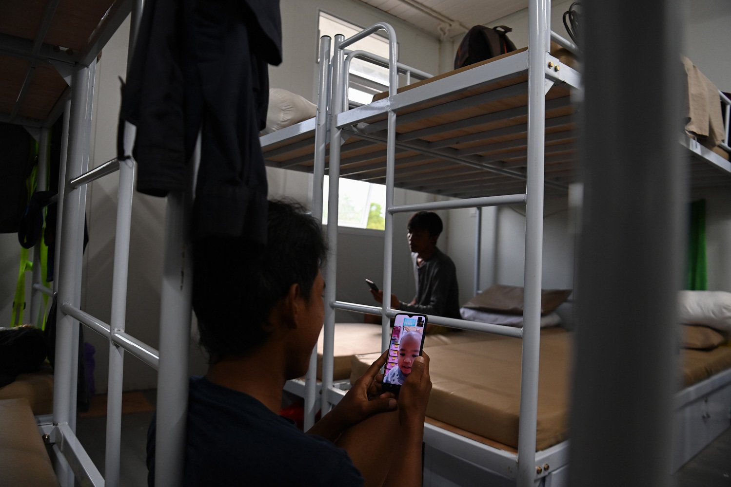 Pekerja melakukan panggilan video di dalam kamar Hunian Pekerja Konstruksi Ibu Kota Nusantara, Penajam Paser Utara, Kalimantan Timur.