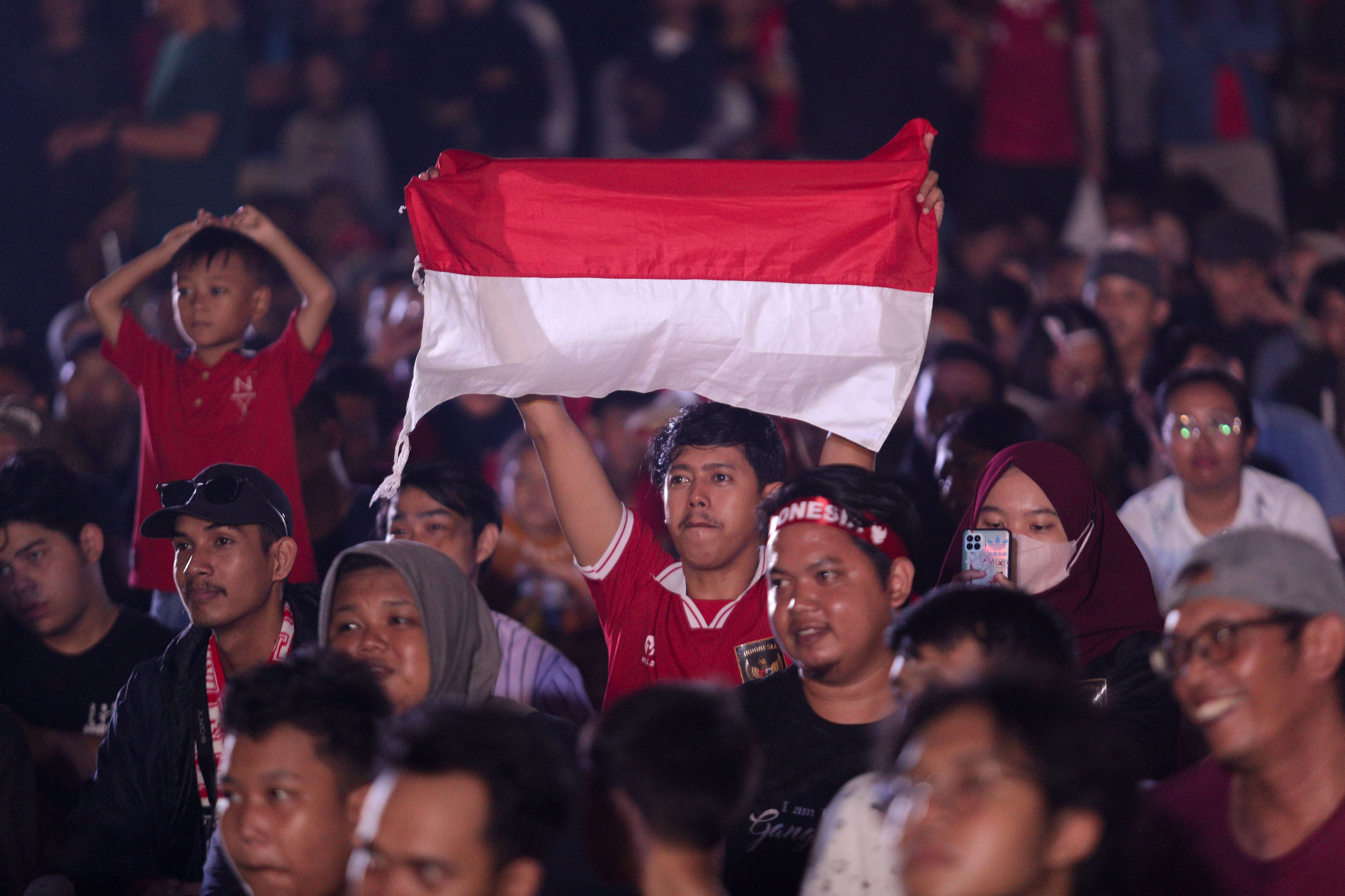 Warga menyaksikan laga playoff Olimpiade 2024 antara Timnas Indonesia U-23 melawan Guinea U-23 di kawasan Stadion Utama Gelora Bung Karno, Jakarta, Kamis (9/5/2024). Pada laga yang digelar di Stadion Clairefontaine, Paris, Prancis tersebut, Timnas Indonesia U-23 kalah dari Guinea U-23 dengan skor akhir 0-1 dan gagal lolos ke Olimpiade 2024.