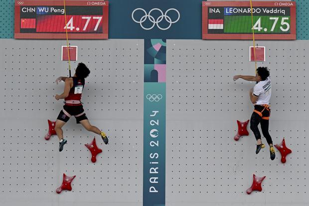 Atlet panjat tebing putra Indonesia Veddriq Leonardo (kanan) mencatatkan waktu tercepat saat menghadapi atlet China Wu Peng pada final nomor speed putra Olimpiade Paris 2024 di Le Bourget Climbing Venue, Paris, Prancis, Kamis (8/8/2024). Veddriq Leonardo berhasil meraih medali emas dengan catatan waktu 4,75 detik.