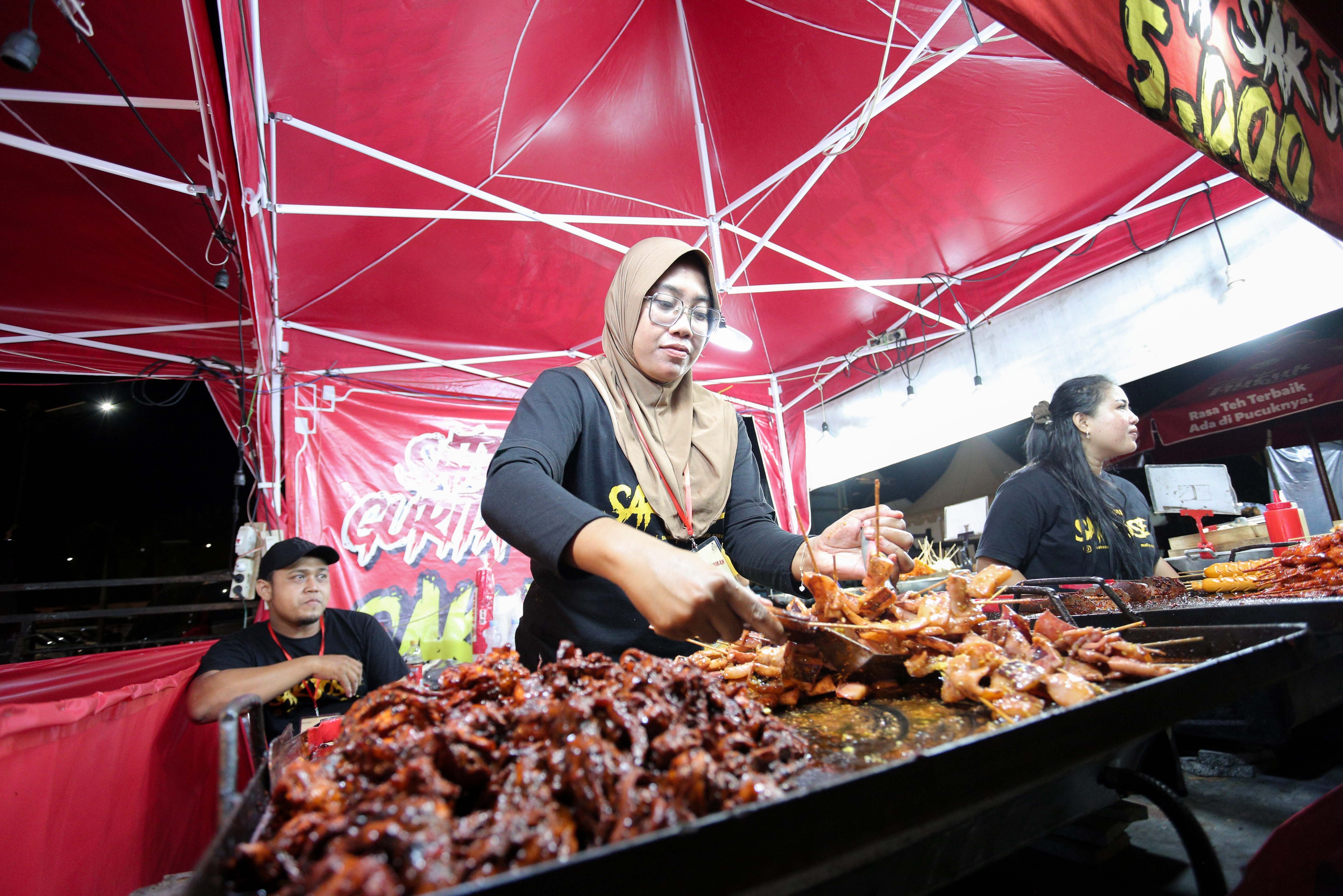 Pedagang memasak sate cumi saat Festival Kuliner Dua Generasi di Pamedan Pura Mangkunegaran, Solo, Jawa Tengah, Sabtu (17/8/2024). Festival kuliner yang merupakan salah satu rangkaian acara pada 