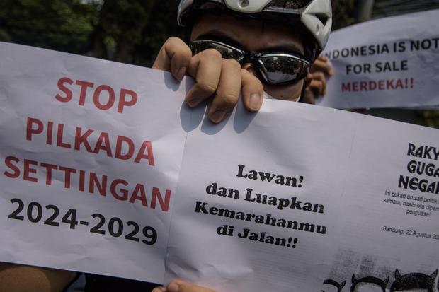 Pengunjuk rasa yang tergabung dalam aliansi mahasiswa dan masyarakat memegang poster saat berunjuk rasa di depan Gedung DPRD Jawa Barat, Bandung, Jawa Barat, Kamis (22/8/24). Aksi tersebut untuk mengawal putusan Mahkamah Konstitusi (MK) terkait ambang batas dalam pilkada dan menolak upaya DPR RI untuk melakukan revisi UU Pilkada.