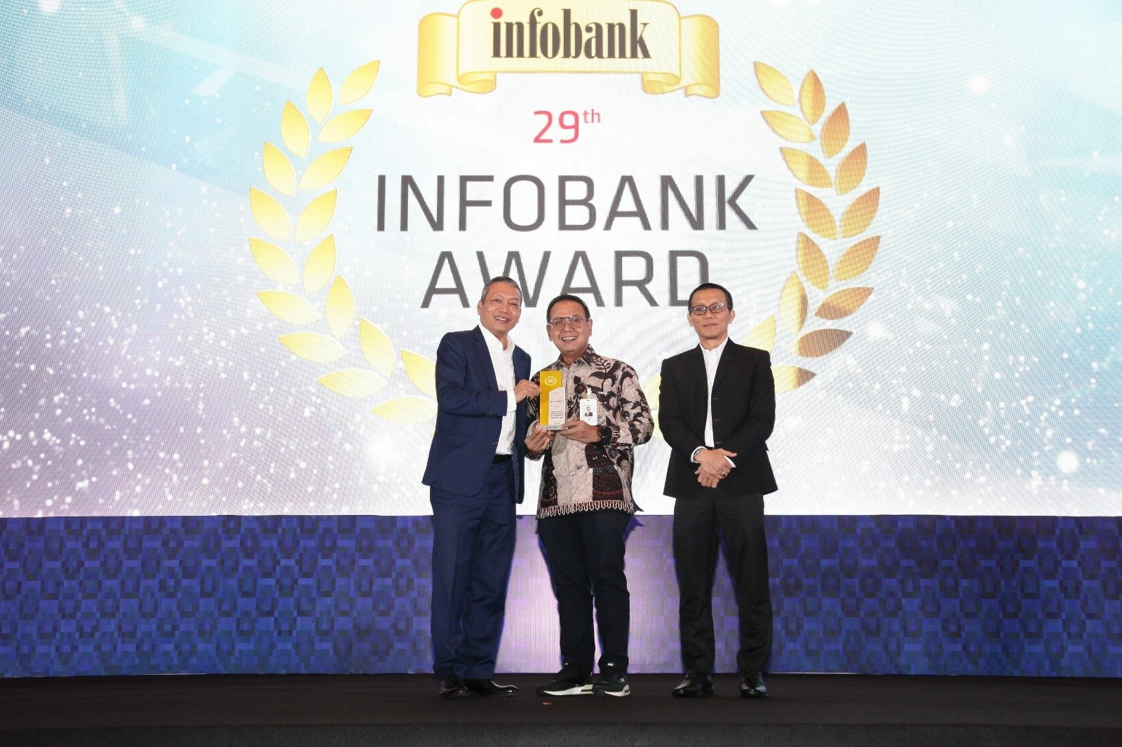 Direktur Keuangan & Strategi Bank DKI, Romy Wijayanto (tengah) menerima penghargaan Golden Trophy The Excellent Performance Bank In 5 Consecutive Years (2018-2023), dalam ajang 29th Infobank Banking Appreciation 2024 dari majalah infobank yang diserahkan oleh Pemimpin Redaksi Infobank, Eko B. Supriyanto (kiri), dan Wakil Pemimpin Redaksi Infobank, Karnoto Mohamad (kanan) di Jakarta (29/08).\r\n