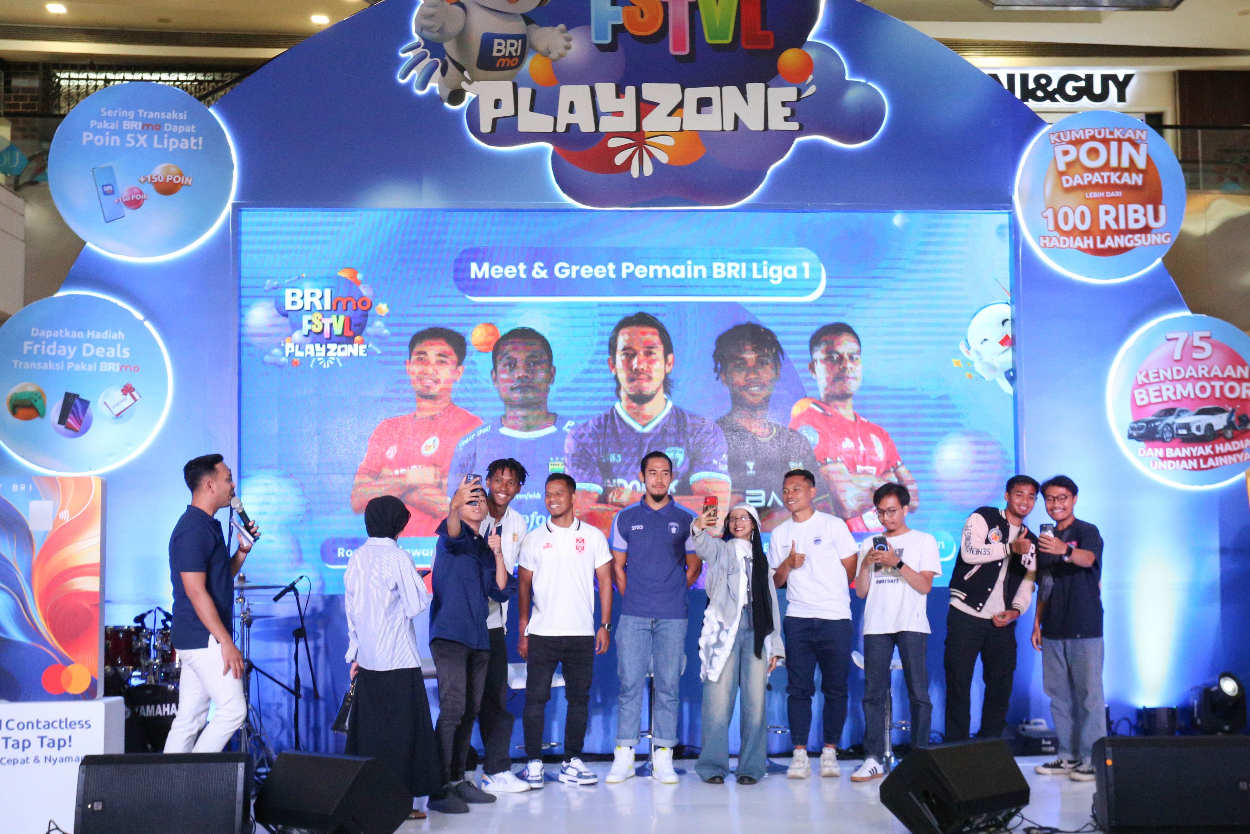 Pamain BRI Liga 1 Alta Ballah (keempat kiri), Manahati Lestusen (kelima kiri), Ryuji Utomo (tengah), Dedi Kusnandar (keempat kanan) dan Rosad Setiawan (kedua kanan) berfoto bersama pengunjung saat sesi meet and greet pada acara BRImo FSTVL Playzone di Fashion Atrium, Mall Kota Kasablanka, Jakarta, Sabtu (12/10/2024). 