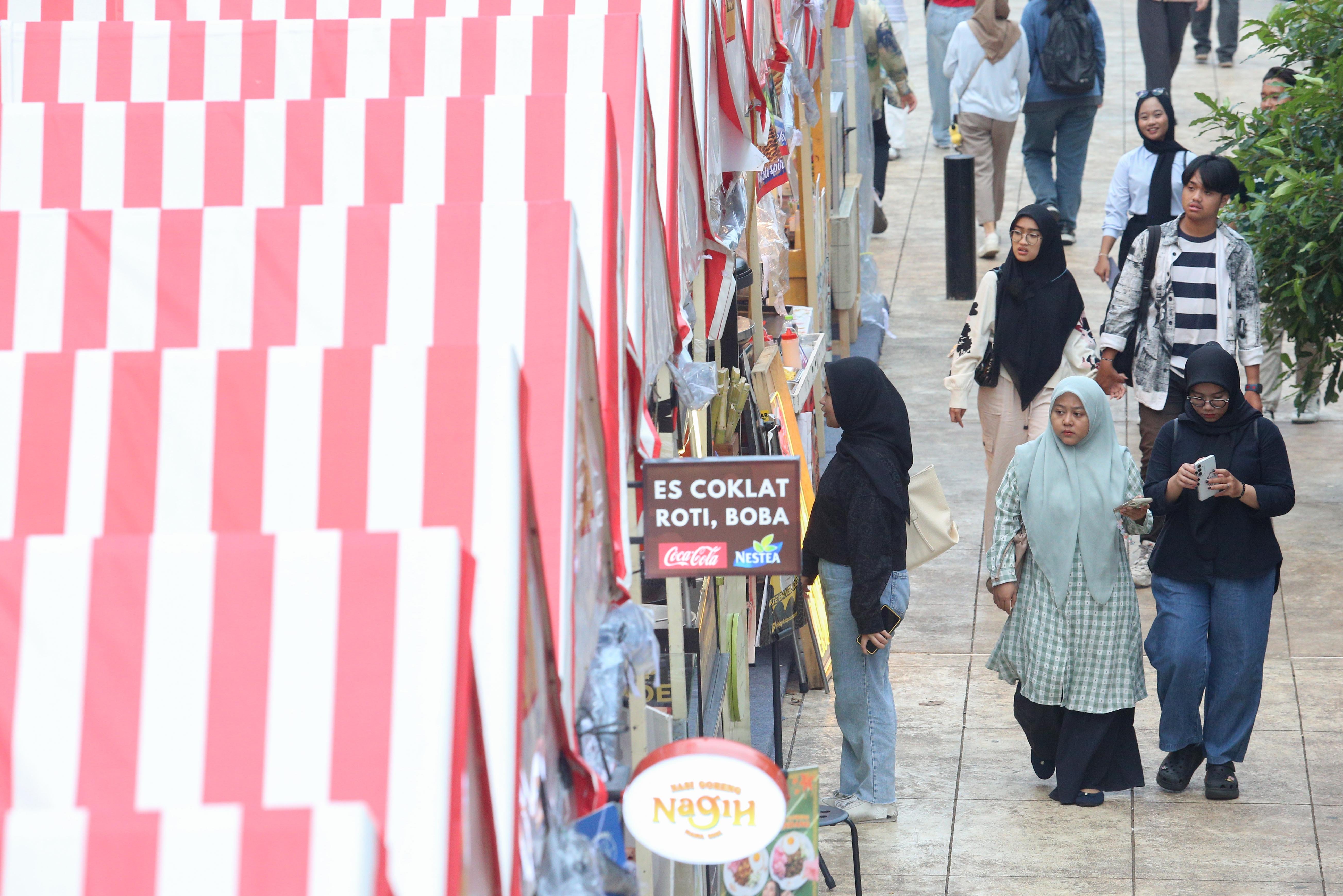 Pengunjung melihat sejumlah tenant makanan pada Festival Kuliner Jajanan Asia di Taman Literasi Martha Christina Tiahahu, Blok M, Jakarta Selatan, Kamis (7/11/2024). Festival kuliner yang menghadirkan makanan khas Asia mulai dari nasi goreng, nasi kandar, gyoza, dakkochi, mie kari hingga bungeoppang ini digelar hingga 10 November mendatang.