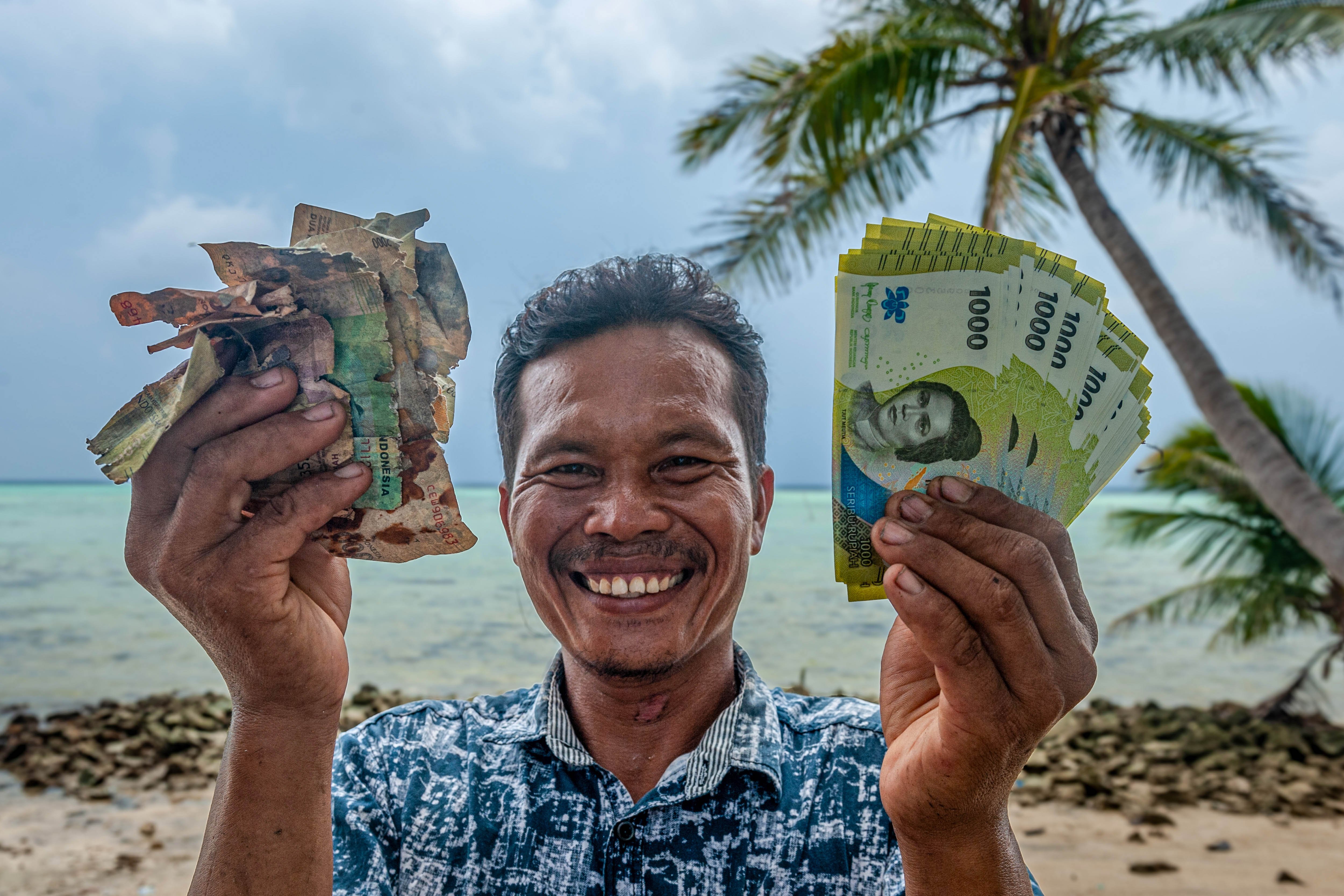 Masri menunjukkan sejumlah lembar uang tidak layak edar dan uang rupiah baru seusai penukaran dari pegawai KPw BI Jateng saat Ekspedisi Rupiah Karimunjawa (ERK-2024) di Pulau Genting, Kepulauan Karimunjawa, Jawa Tengah.