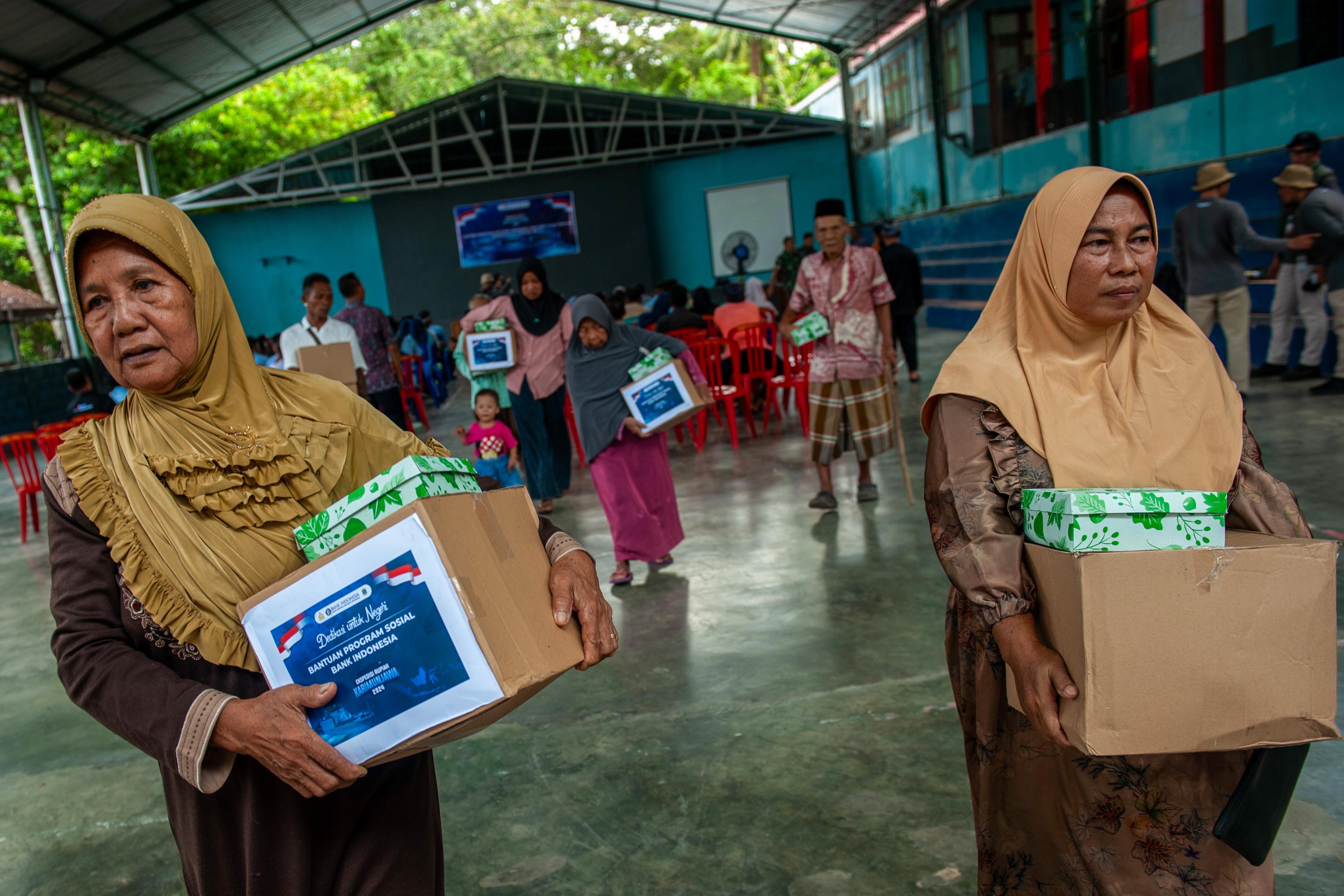 Warga membawa bantuan paket sembako dari program sosial BI di sela-sela Ekspedisi Rupiah Karimunjawa (ERK-2024).