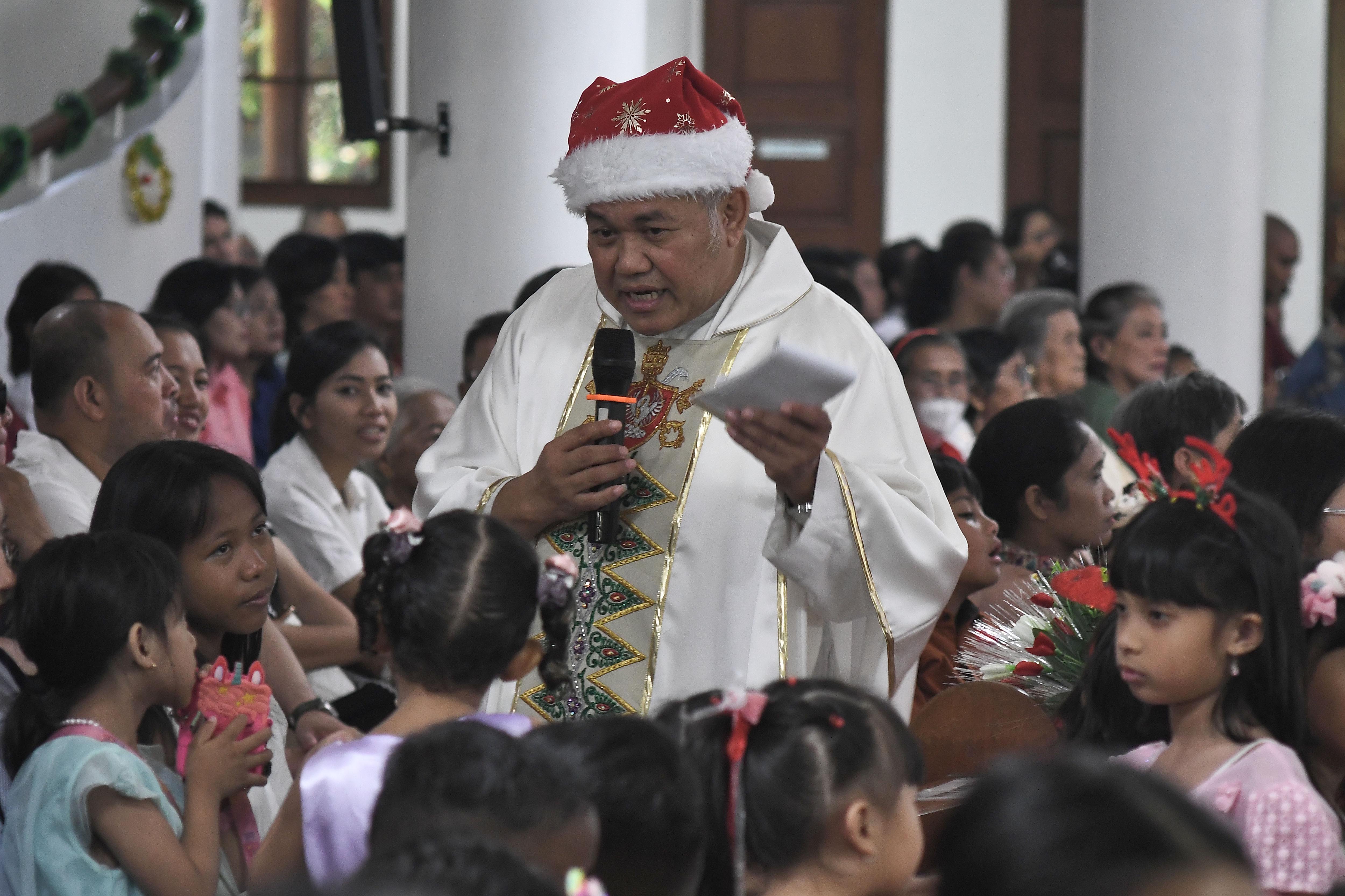Romo Wahono (tengah) berbincang dengan anak-anak usai memimpin Misa Natal di Gereja Katolik Santo Servatius, Kampung Sawah, Bekasi, Jawa Barat, Rabu (25/12/2024). Gereja tersebut mengangkat tema Natal Marilah Sekarang Kita Pergi ke Bethlehem, yang berisi pesan tentang kesetiaan dan kesediaan dalam mengikuti panggilan Tuhan. 