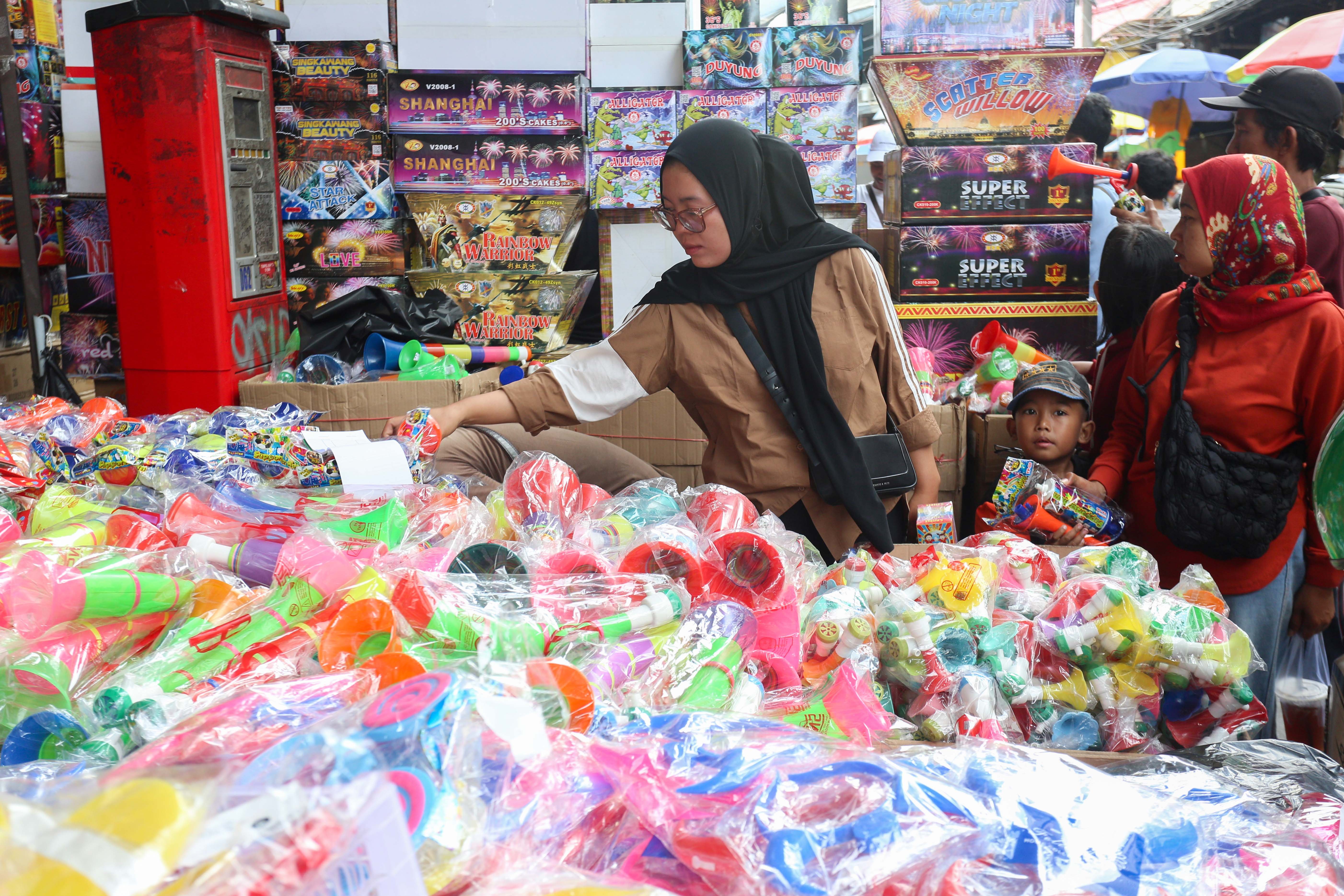 Pembeli memilih terompet yang dijual di Pasar Asemka, Jakarta, Senin (30/12/2024). Menjelang tahun baru 2025 sejumlah warga mulai mencari terompet untuk memeriahkan malam pergantian tahun dengan harga terompet mulai dari Rp.15.000 hingga Rp.25.000 tergantung jenis dan ukurannya.