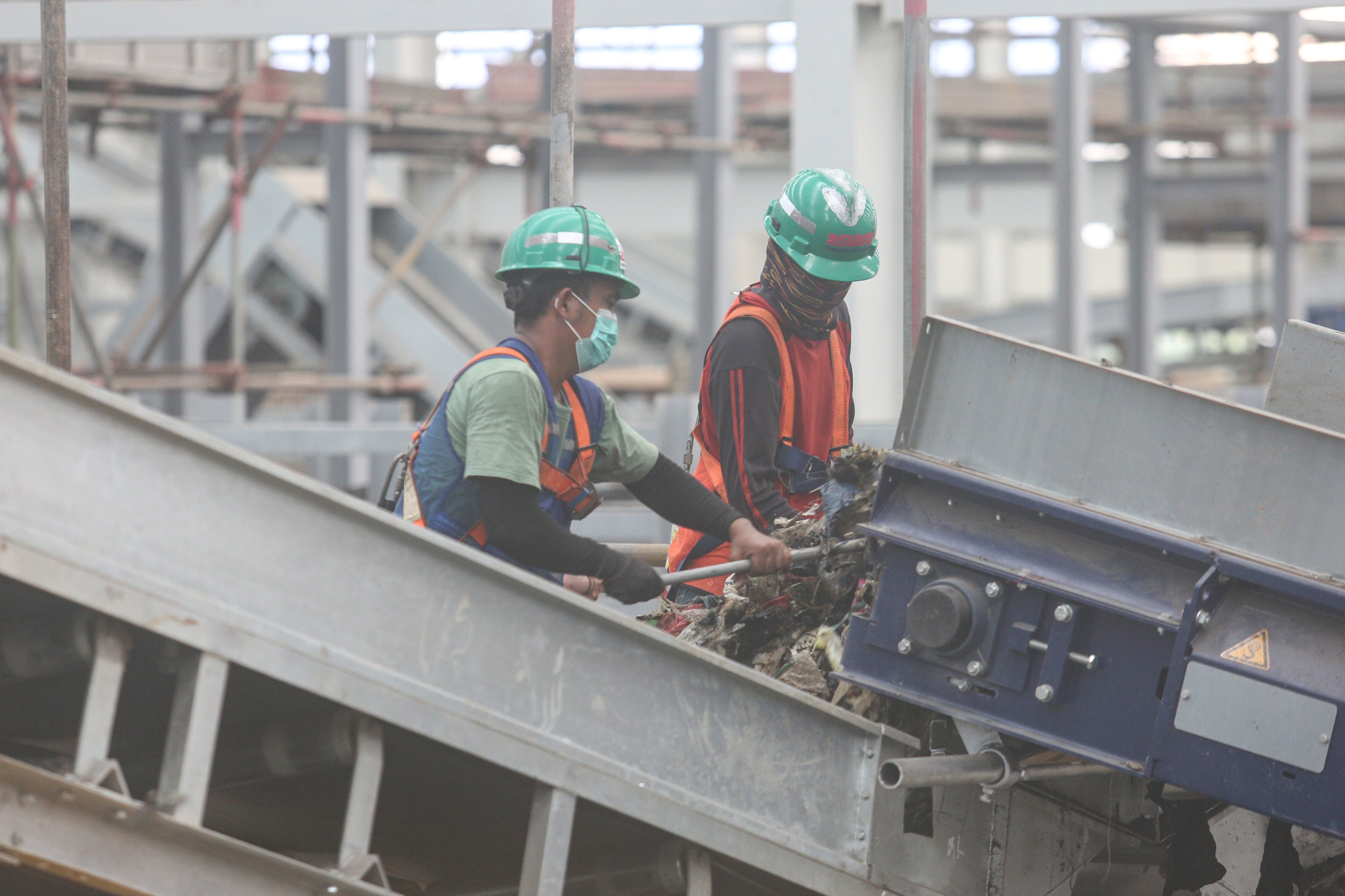 Pekerja mengeluarkan sampah dari mesin pengolahan sampah di Refuse Derived Fuel (RDF) Plant Rorotan, Jakarta Utara, Selasa (25/2/2025). Pabrik pengolahan sampah yang mampu mengolah sebanyak 2.500 ton sampah per hari yang diubah menjadi bahan bakar alternatif ini menjadi solusi untuk mengurangi sekitar 30% volume sampah Jakarta yang dikirim ke Tempat Pengolahan Sampah Terpadu (TPST) Bantargebang.