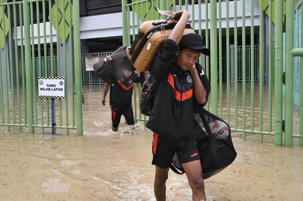 Official Tim Persija Jakarta membawa bola dan perlengkapan keluar Stadion Patriot Chandrabhaga, Bekasi, Jawa Barat, Selasa (4/3/2025). Menurut Kepala Unit Pelaksana Teknis Daerah (UPTD) Stadion tersebut pertandingan Persija Jakarta melawan PSIS Semarang pada (4/3) pukul 20.30 WIB ditunda karena kondisi ruangan Stadion Patriot tergenang banjir luapan Kali Bekasi.