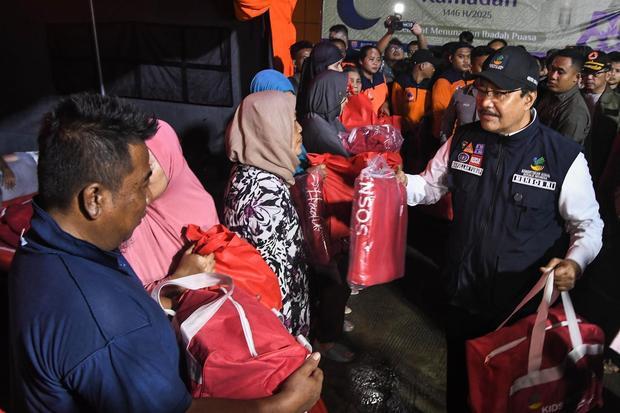 Menteri Sosial Saifullah Yusuf (kanan) memberikan paket bantuan kepada warga yang terdampak banjir di pengungsian Gudang BNPB, Jatirasa, Bekasi, Jawa Barat, Selasa (4/3/2025). Kementerian sosial memberikan bantuan kepada pengungsi banjir di Bekasi yaitu berupa 2.000 paket makanan siap saji, 100 paket baju anak, 200 lembar selimut, 100 lembar kasur dan bantuan perahu karet untuk evakuasi dengan nilai total Rp523 juta.
