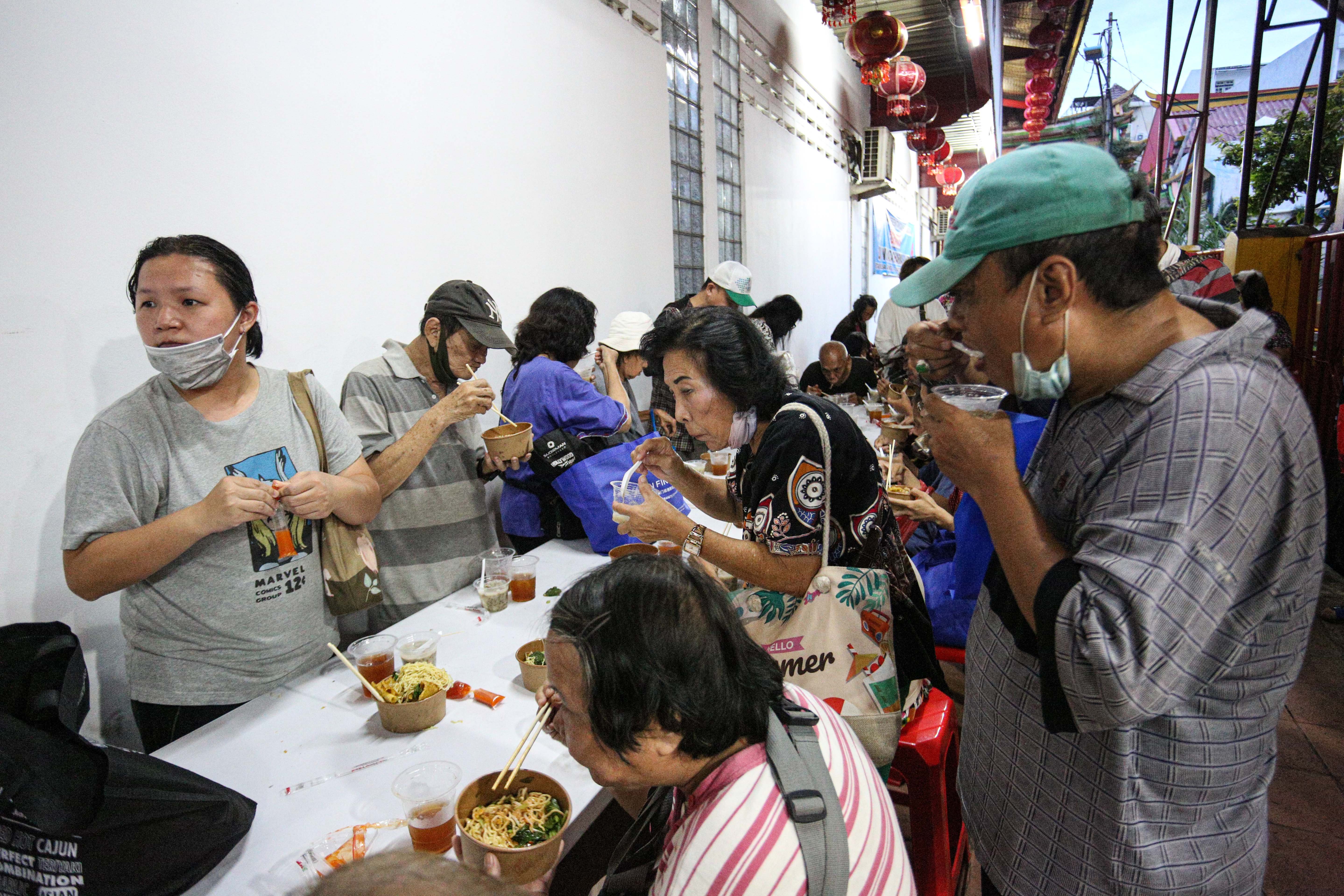 Sejumlah warga menyantap makanan yang dibagikan pada acara buka bersama di Vihara Dharma Bakti, Petak Sembilan, Glodok, Jakarta Barat, Senin (10/3/2025). Kegiatan yang digelar sebagai bentuk toleransi antar umat beragama dengan membagikan 350 porsi makanan buka puasa bagi umat muslim tersebut berlangsung hingga 24 Maret 2025. 