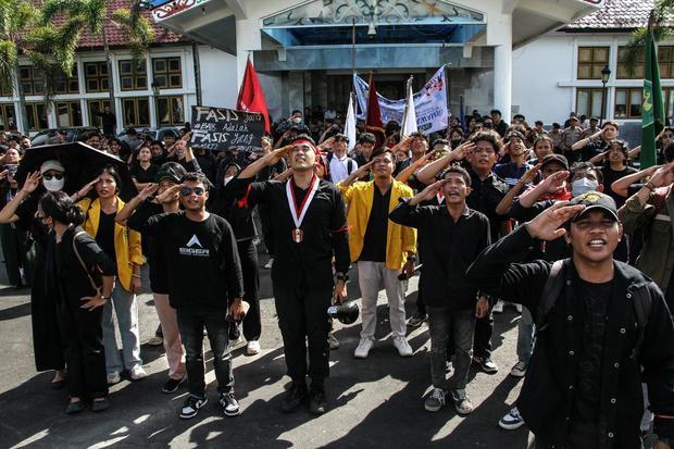 Pengunjuk rasa memberi hormat pada bendera Merah Putih saat aksi menyikapi UU TNI di kantor DPRD Kalimantan Tengah, Palangka Raya, Senin (24/3/2025).