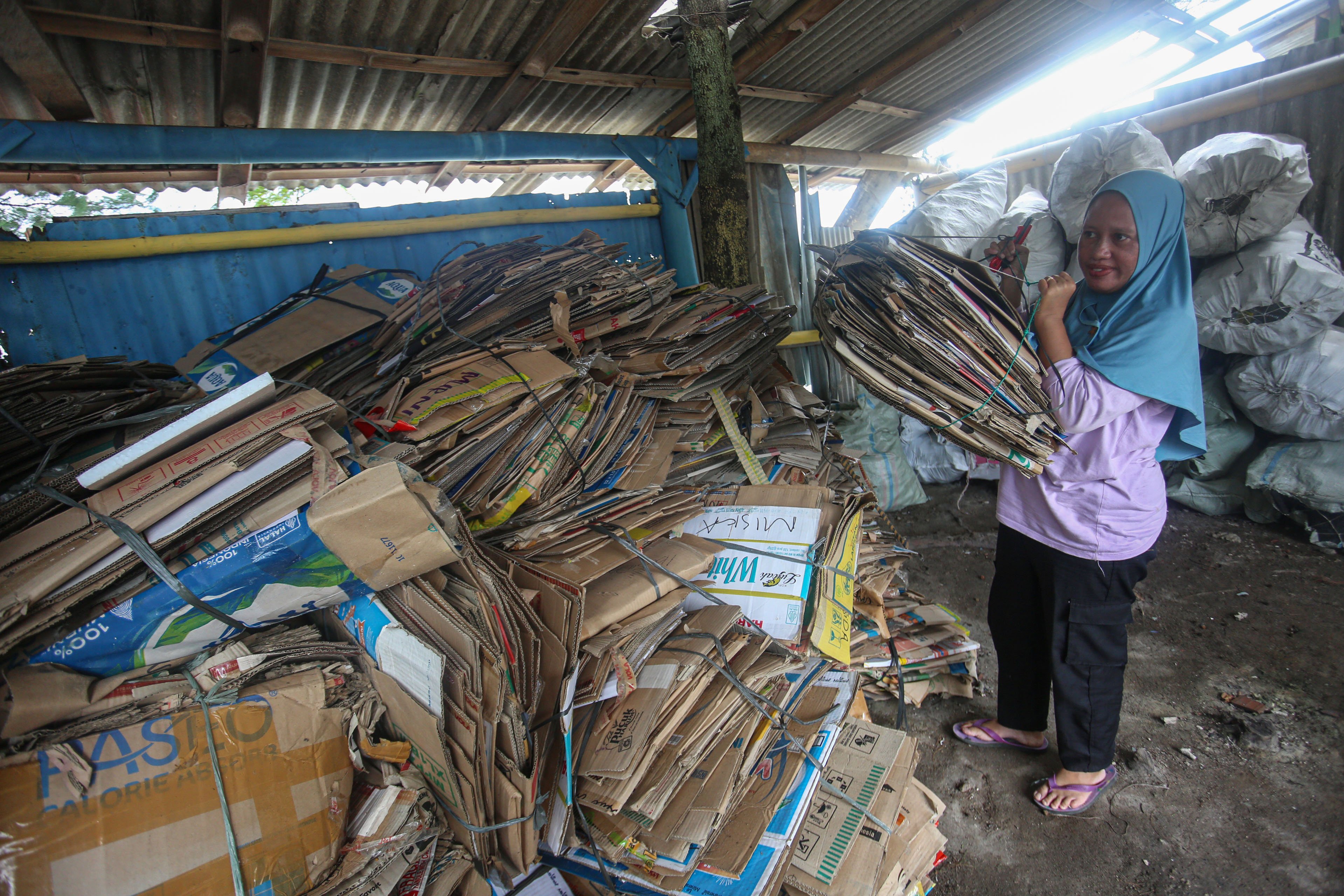 Anggota bank sampah membawa kardus bekas untuk disetorkan ke Bank Sampah Kelapa Dua Indah di Pulau Kelapa Dua, Kepulauan Seribu, Jakarta, Kamis (24/4/2025). Bank sampah yang telah beroperasi sejak tahun 2019 ini mampu berkontribusi dalam meningkatkan kesadaran dan partisipasi warga dalam pengelolaan sampah di pulau tersebut dan juga menjadi sumber pemasukan tambahan bagi warga melalui sampah yang disetorkan ke bank sampah. 