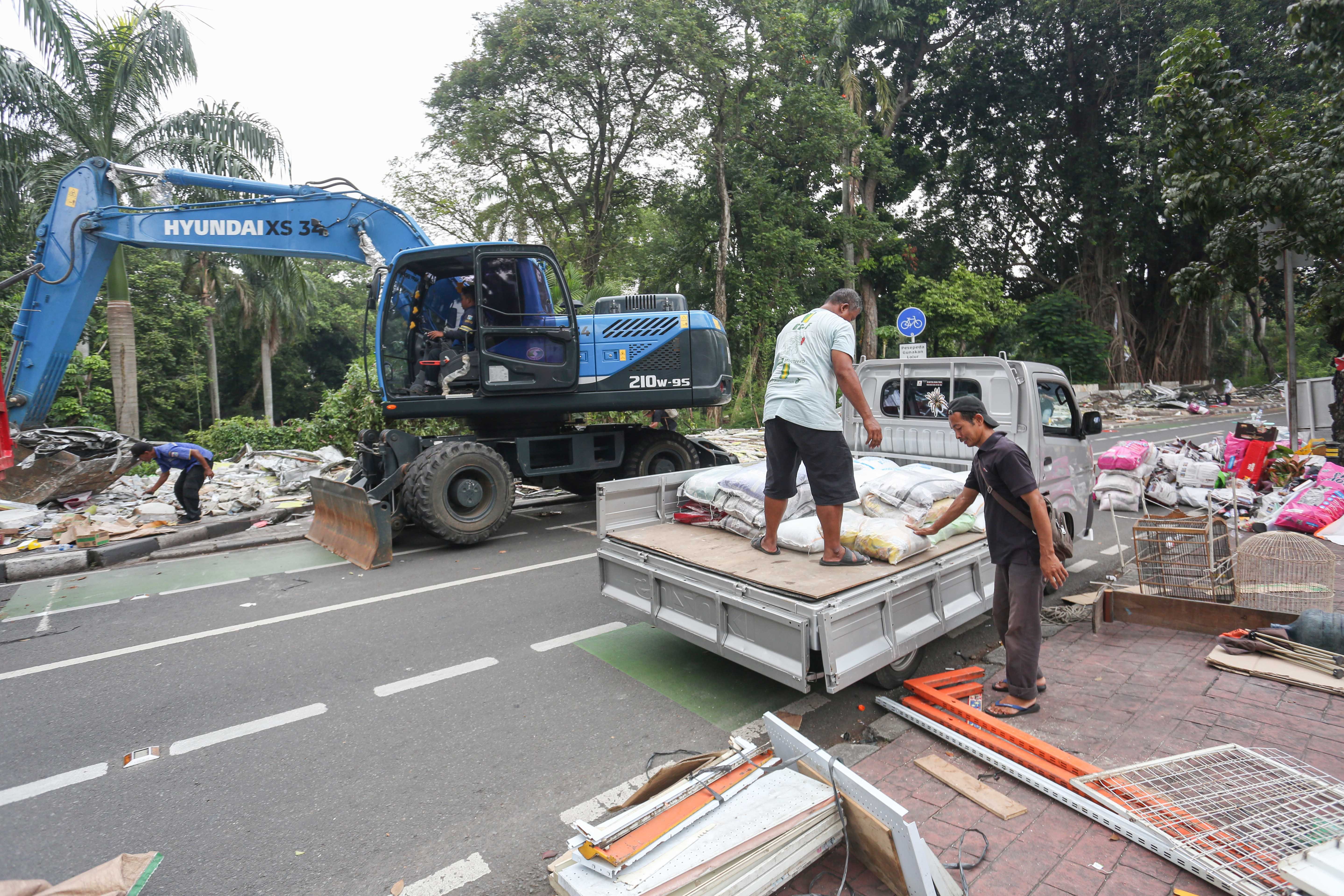 Pedagang mengangkut barang dagangannya saat pembongkaran kios di Pasar Barito, Jakarta, Senin (27/10/2025). Pemerintah Kota Jakarta Selatan merelokasi pedagang Pasar Barito ke Sentra Fauna dan Kuliner Lenteng Agung untuk membangun Taman Bendera Pusaka.