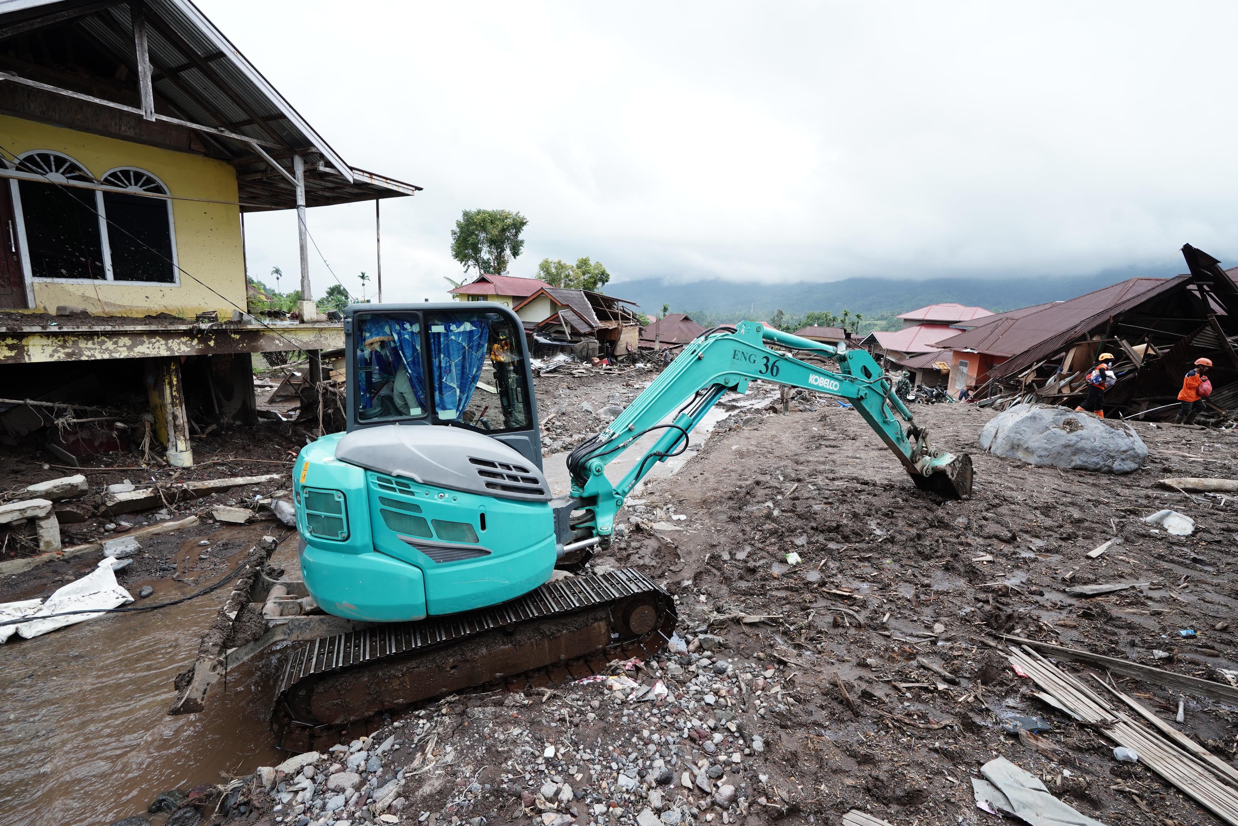 Petugas menggunakan alat berat untuk membersihkan lumpur sisa banjir bandang dan tanah longsor di Kecamatan Malalak, Kabupaten Agam, Sumatera Barat, Minggu (7/12/2025). Sebanyak tiga dusun atau jorong di wilayah tersebut masih terisolir karena terputusnya akses jalan sehingga membuat distribusi logistik terhambat.