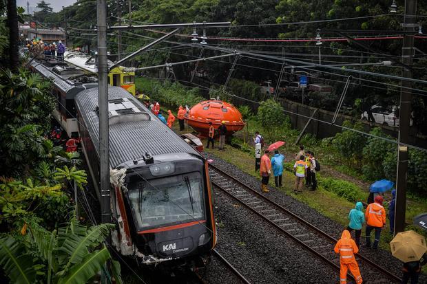 Petugas melihat kondisi rangkaian kereta api (KA) Bandara Soekarno-Hatta yang anjlok di Poris, Kota Tangerang, Banten, Jumat (20/2/2026). Kereta api Bandara Soekarno-Hatta tersebut mengalami anjlok setelah menabrak truk di pelintasan sebidang JPL 21 sehingga menutup akses jalan dan membuat rute perjalanan KRL terganggu.