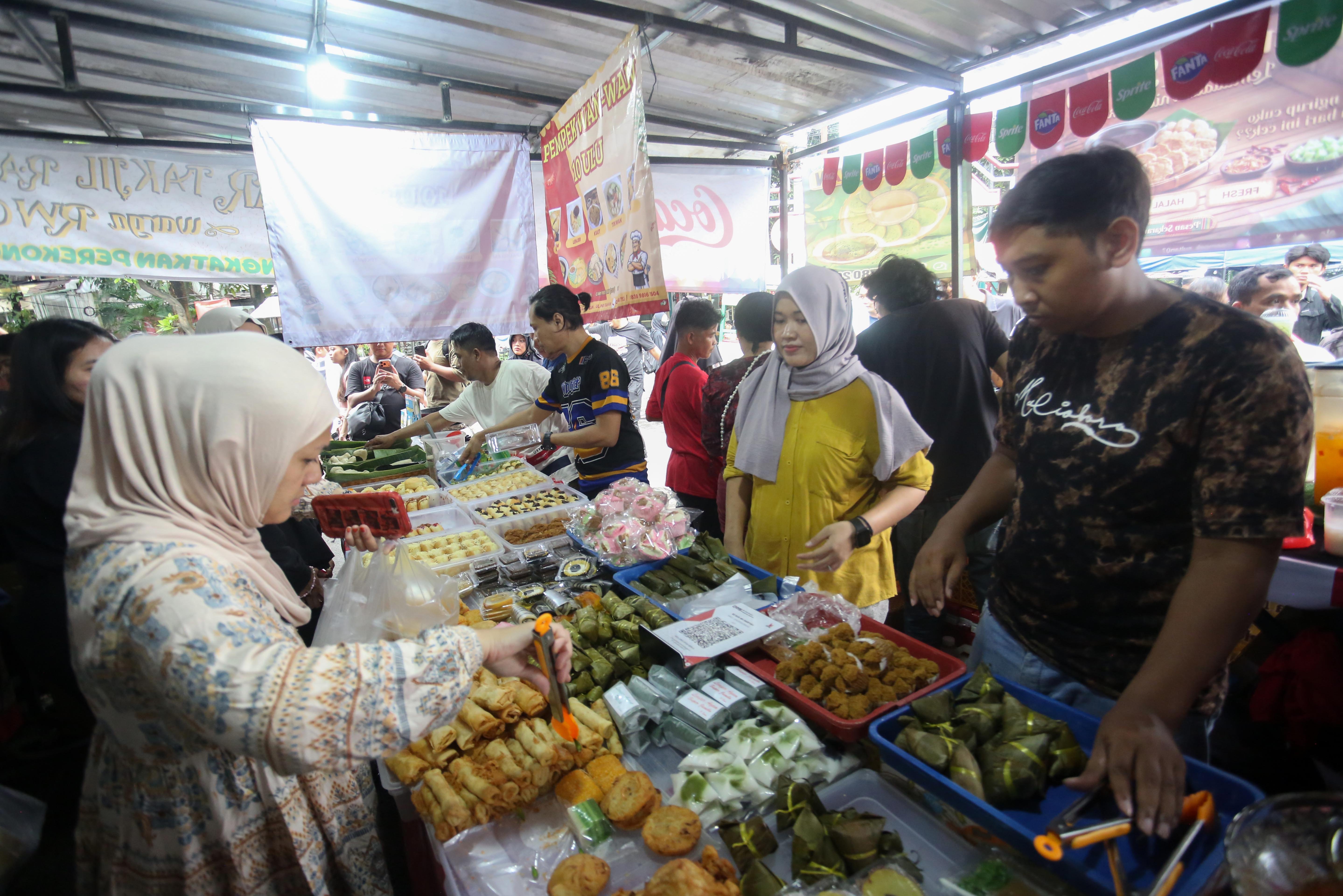 Warga membeli takjil yang dijual di Pasar Takjil Bendungan Hilir, Jakarta Pusat, Kamis (19/2/2026). Bazar yang rutin digelar setiap bulan Ramadan ini menjadi salah satu lokasi favorit bagi warga untuk berburu takjil mulai dari aneka gorengan, kue tradisional hingga makanan berat seperti ayam goreng dan ikan bakar.