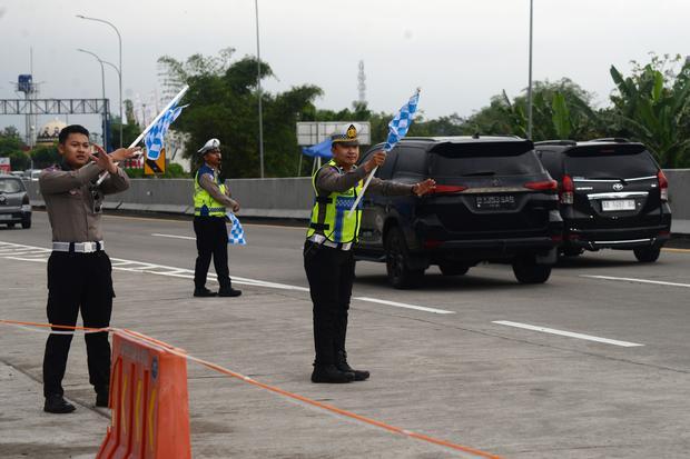 Anggota Satlantas Polres Boyolali mengatur arus lalu lintas yang melintasi jalan tol Solo-Semarang KM 487 di Boyolali, Jawa Tengah, Rabu (25/3/2026). Berdasarkan data Korlantas Polri volume kendaraan saat puncak arus balik Lebaran 2026 pada Selasa 24 Maret 2026 mencapai 256.388 kendaraan jumlah tersebut naik dibanding tahun sebelumnya yaitu 223.163 kendaraan.