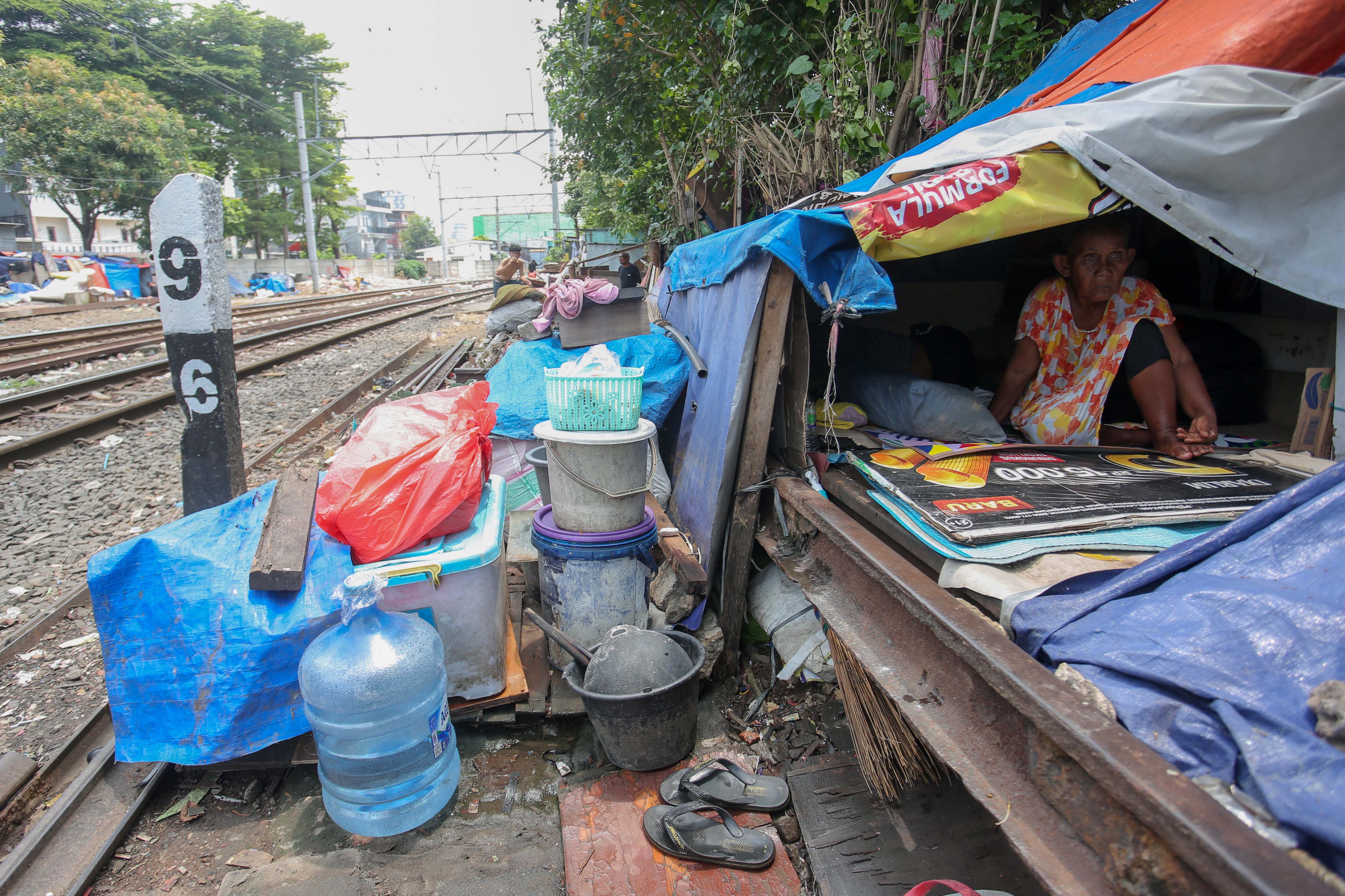 Seorang warga berada di dalam tempat tinggalnya di bantaran rel kereta api, kawasan Senen, Jakarta Pusat, Senin (30/3/2026). Presiden Prabowo Subianto menyatakan bahwa akan membangun hunian layak bagi warga yang tinggal di pinggir rel kawasan tersebut.