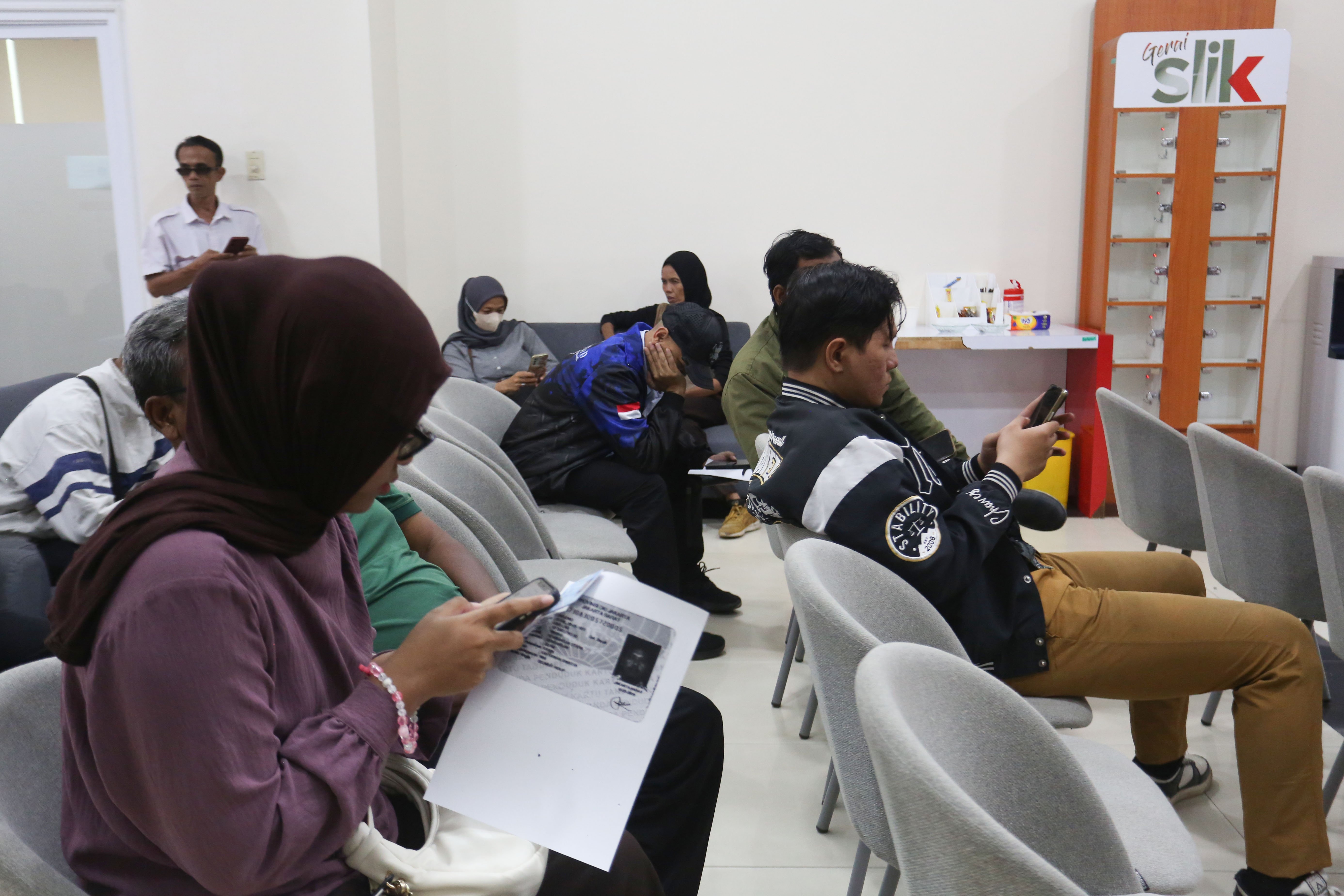 Warga mengantre untuk mengecek catatan kredit melalui Sistem Layanan Informasi Keuangan (SLIK) di Kantor Otoritas Jasa Keuangan, Jakarta, Rabu (22/4/2026). Kementerian Perumahan dan Kawasan Permukiman bersama Otoritas Jasa Keuangan mengeluarkan kebijakan baru yakni masyarakat dengan catatan kredit sebesar Rp 1 juta ke bawah di Sistem Layanan Informasi Keuangan (SLIK) dapat mengajukan kredit rumah subsidi.