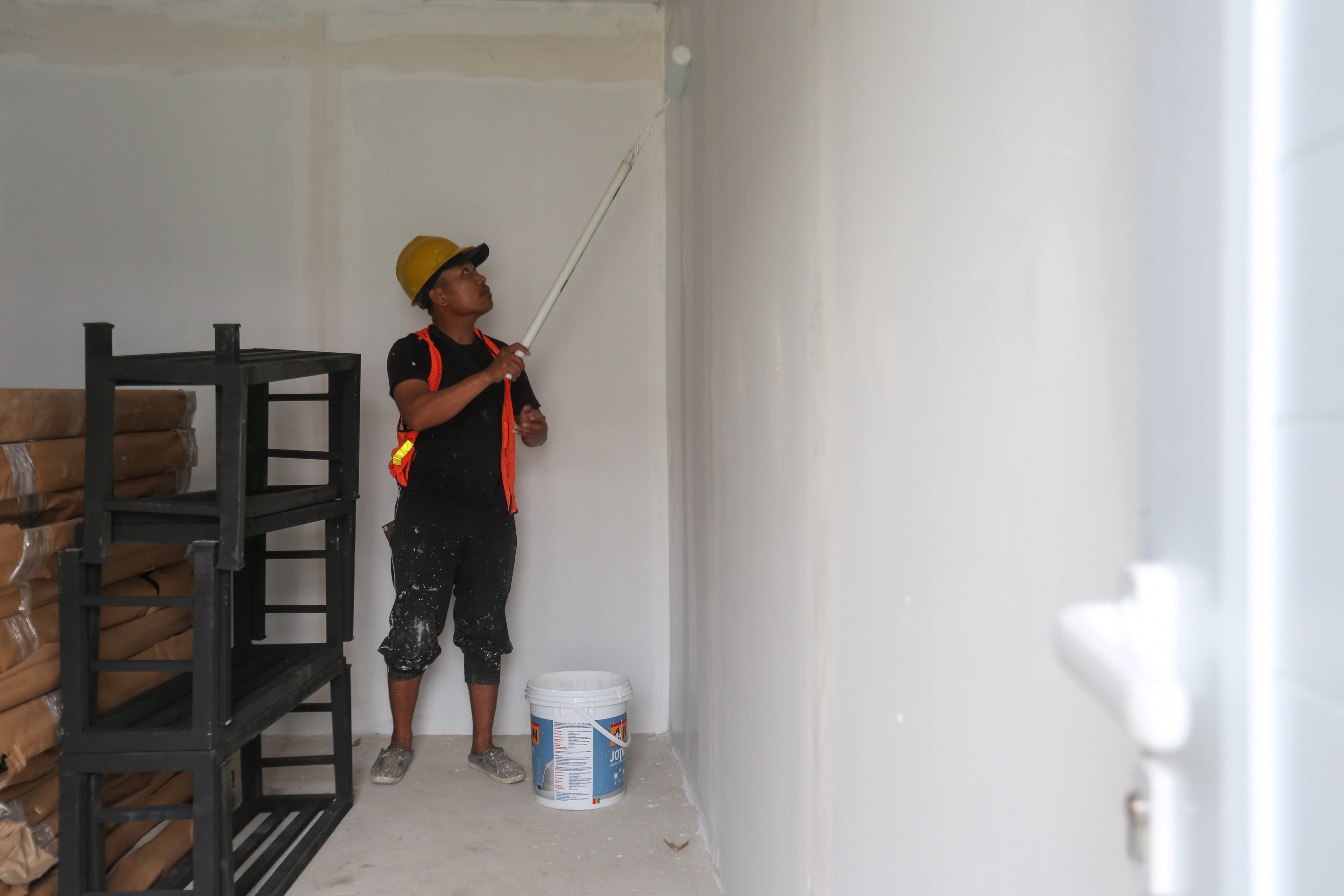 Pekerja mengecat tembok saat pembangunan hunian layak di kawasan Senen, Jakarta, Kamis (23/4/2026). Kementerian Perumahan dan Kawasan Permukiman (PKP) membangun 324 unit rumah yang dilengkapi fasilitas seperti dapur umum, toilet komunal dan musala untuk warga yang tinggal di bantaran rel kereta api Pasar Senen.