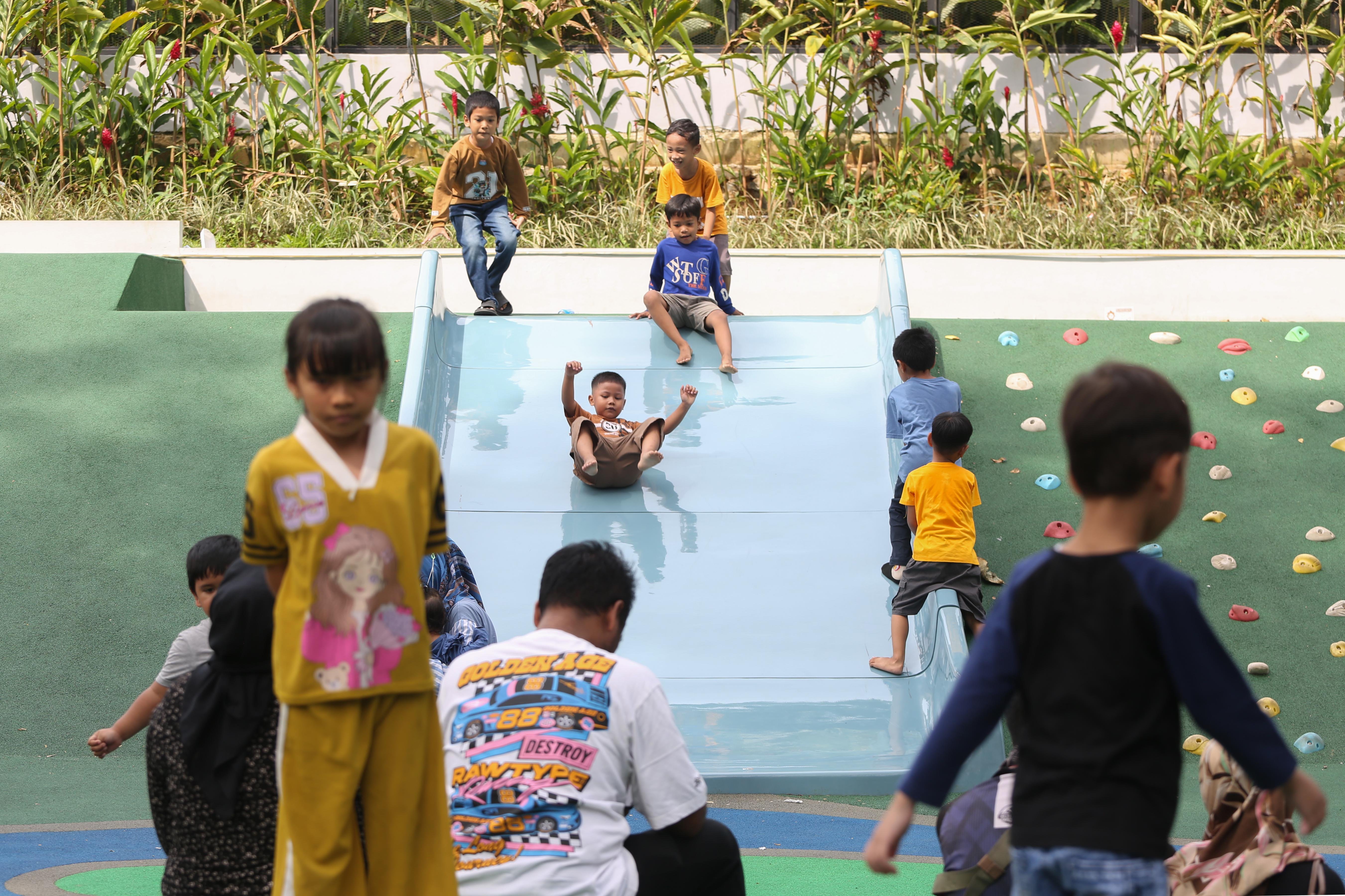 Sejumlah anak bermain di area Taman Bendera Pusaka, Kebayoran Baru, Jakarta Selatan, Sabtu (25/4/2026). Taman seluas 5,6 hektare yang menawarkan suasana asri dan dilengkapi dengan fasilitas seperti area piknik, lapangan olahraga, hingga tempat bermain anak ini menjadi destinasi wisata baru bagi masyarakat dalam menghabiskan waktu akhir pekan.