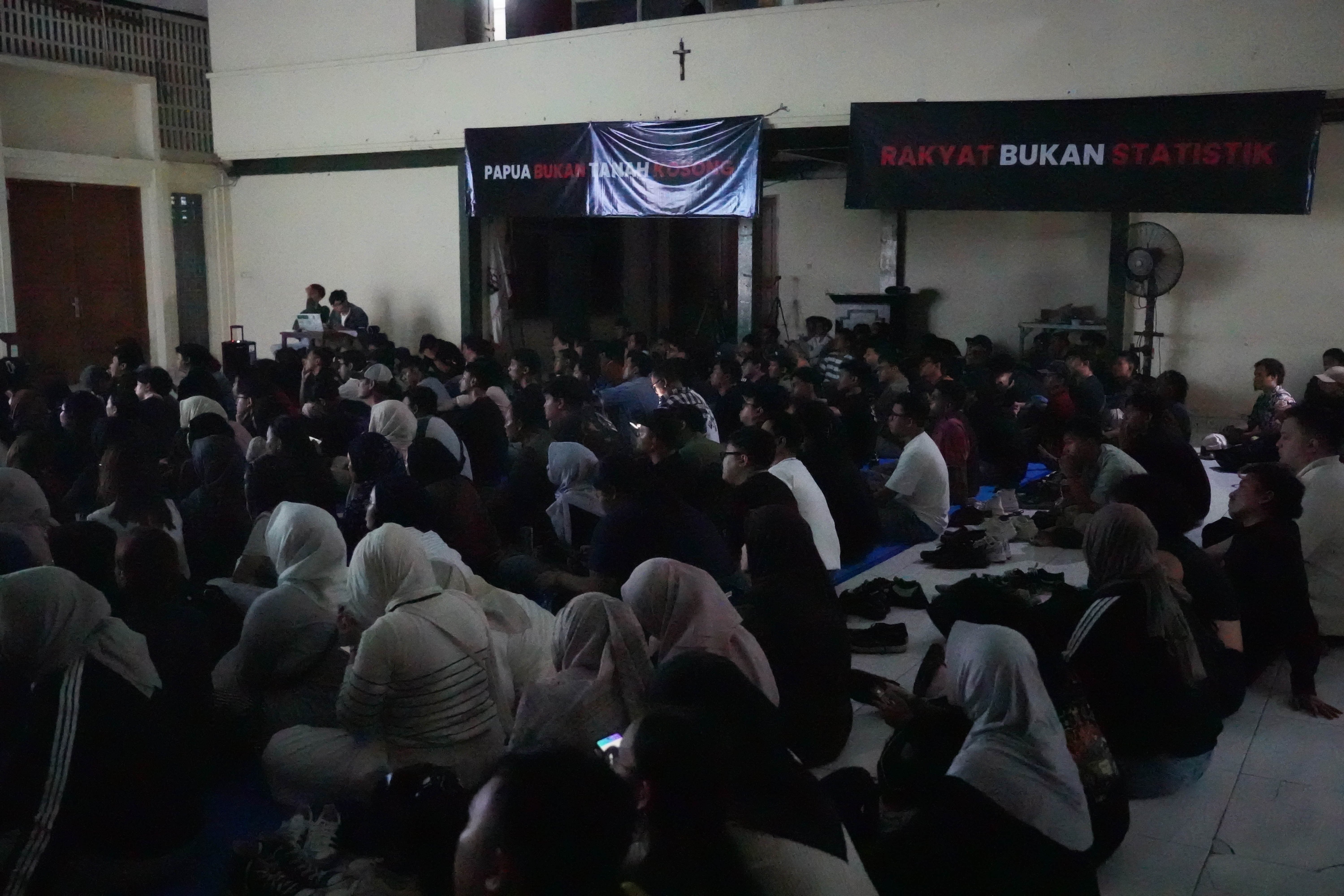 Suasana nonton bareng film Pesta Babi di sekretariat Perhimpunan Mahasiswa Katolik Republik Indonesia, Menteng, Jakarta Pusat, Sabtu (23/5/2026). Film dokumenter tersebut mengangkat isu mengenai proyek pembangunan di Papua Selatan yang disebut membuat masyarakat adat kehilangan tanah dan ruang hidup akibat ekspansi proyek perkebunan tebu, sawit, hingga food estate.