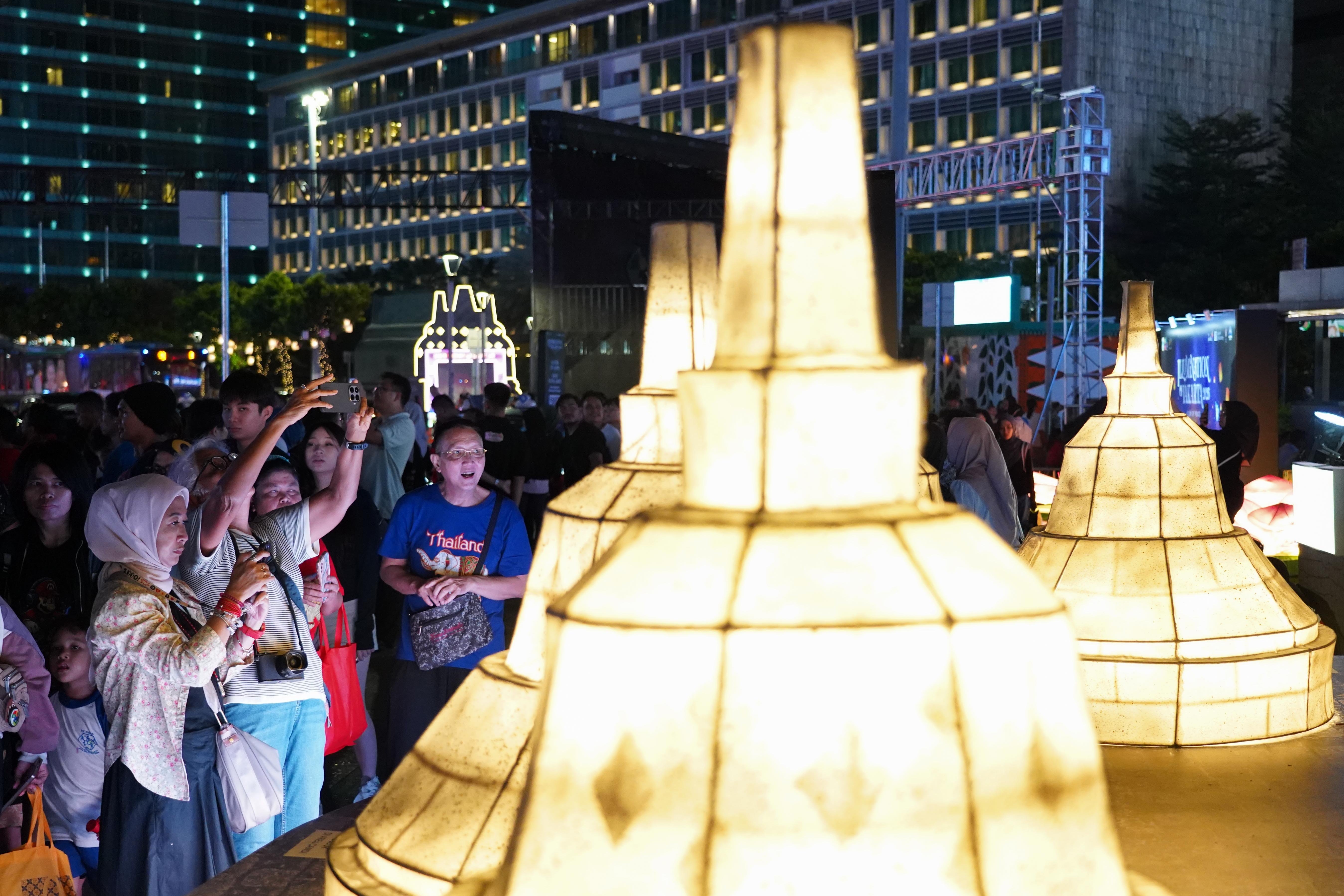 Sejumlah warga menyaksikan instalasi cahaya dalam gelaran Illumination of Jakarta: Glow of Peace di kawasan Bundaran HI, Jakarta, Jumat (29/5/2026). Acara yang digelar Pemprov DKI Jakarta untuk menyambut Hari Raya Waisak 2570 BE ini menghadirkan ornamen lampu hias, pertunjukan budaya, serta doa dan renungan bersama yang mengusung pesan perdamaian dan refleksi diri, serta berlangsung hingga 1 Juni 2026.