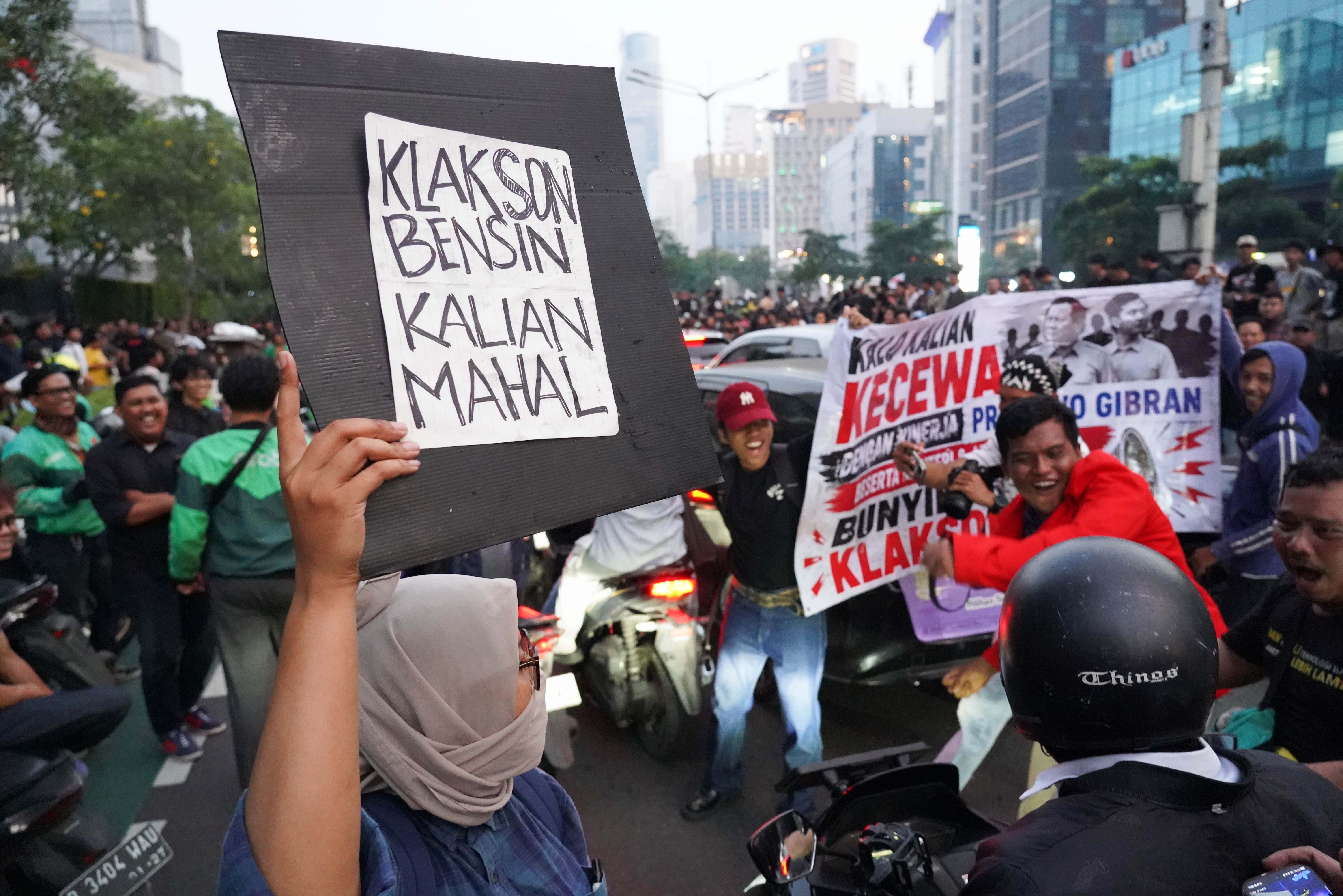 Warga membawa poster tuntutan saat berdemonstrasi bersama mahasiswa di kawasan Jalan MH Thamrin, Jakarta Pusat, Jumat (12/6/2026). Dalam aksi tersebut mereka menyampaikan tuntutan kepada pemerintah diantaranya hentikan pemborosan APBN dengan menyetop program Makan Bergizi Gratis (MBG) karena dinilai tidak efektif serta turunkan harga kebutuhan pokok dan bahan bakar minyak (BBM) yang membebani masyarakat.