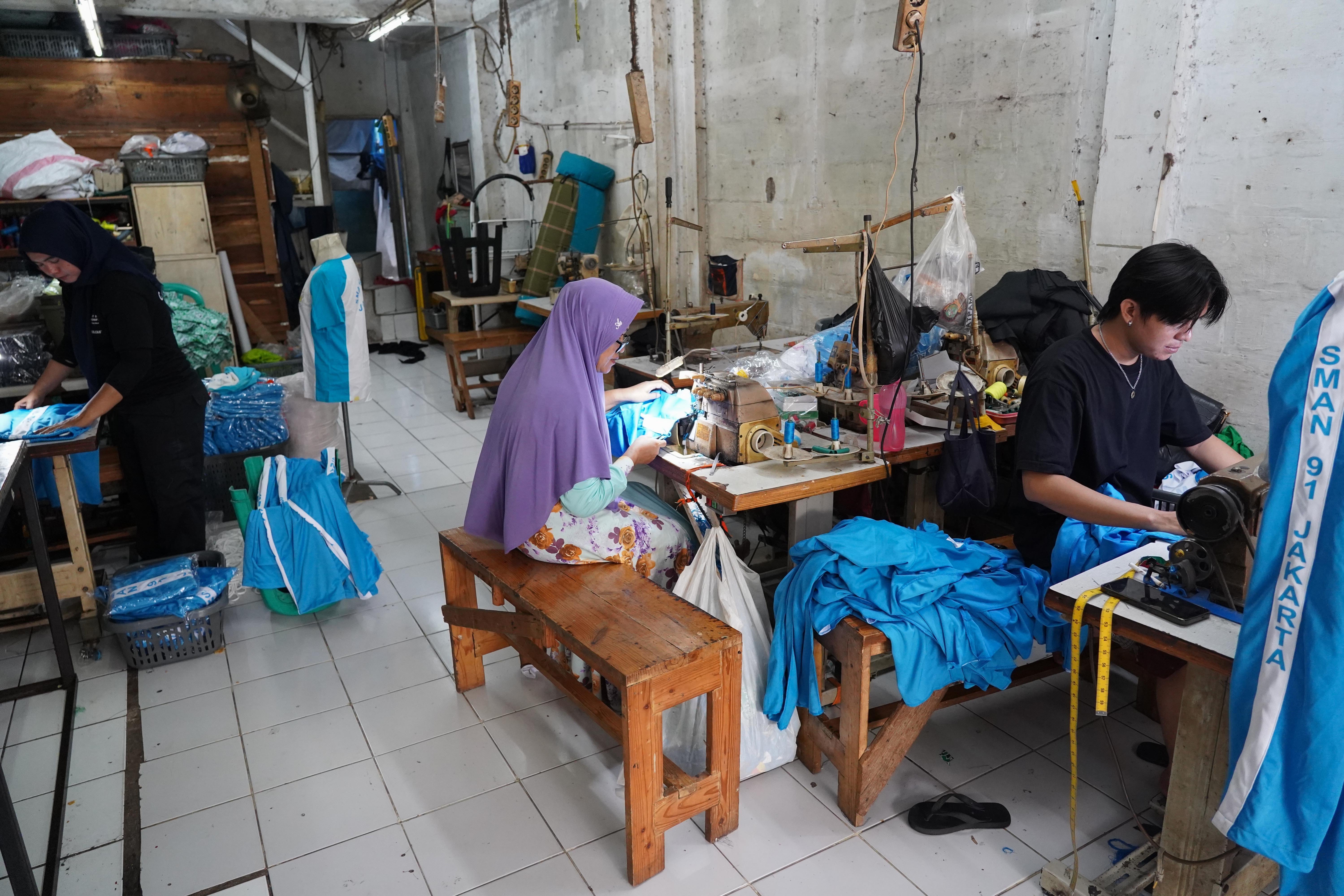 Pekerja menyelesaikan pembuatan seragam sekolah di Andor Apparel, Jalan Busana 3, Penggilingan, Cakung, Jakarta Timur, Jumat (3/7/2026). Menjelang tahun ajaran baru 2026/2027 usaha konveksi tersebut memproduksi pesanan seragam sekolah sebanyak 1.000 pcs mulai dari baju batik dan olahraga hingga atribut seperti topi, dasi dan gesper.