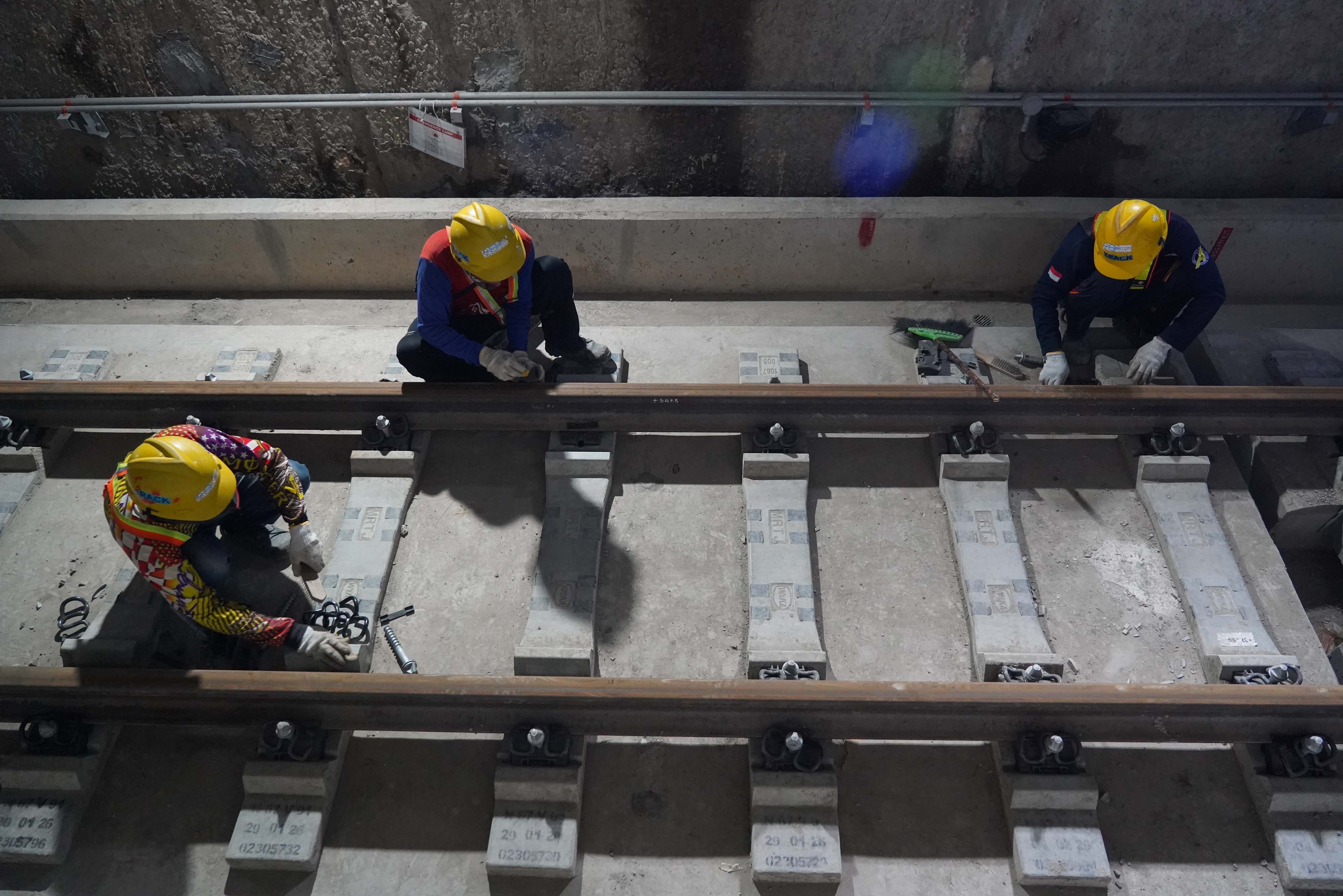 Pekerja menyelesaikan pembangunan rel pada Stasiun MRT Monas, Jakarta, Rabu (22/7/2026). Stasiun yang dirancang sebagai stasiun ikonik yang menyatu dengan kawasan cagar budaya Monumen Nasional ini progres konstruksinya telah mencapai sekitar 92% dan ditargetkan beroperasi pada akhir 2027.