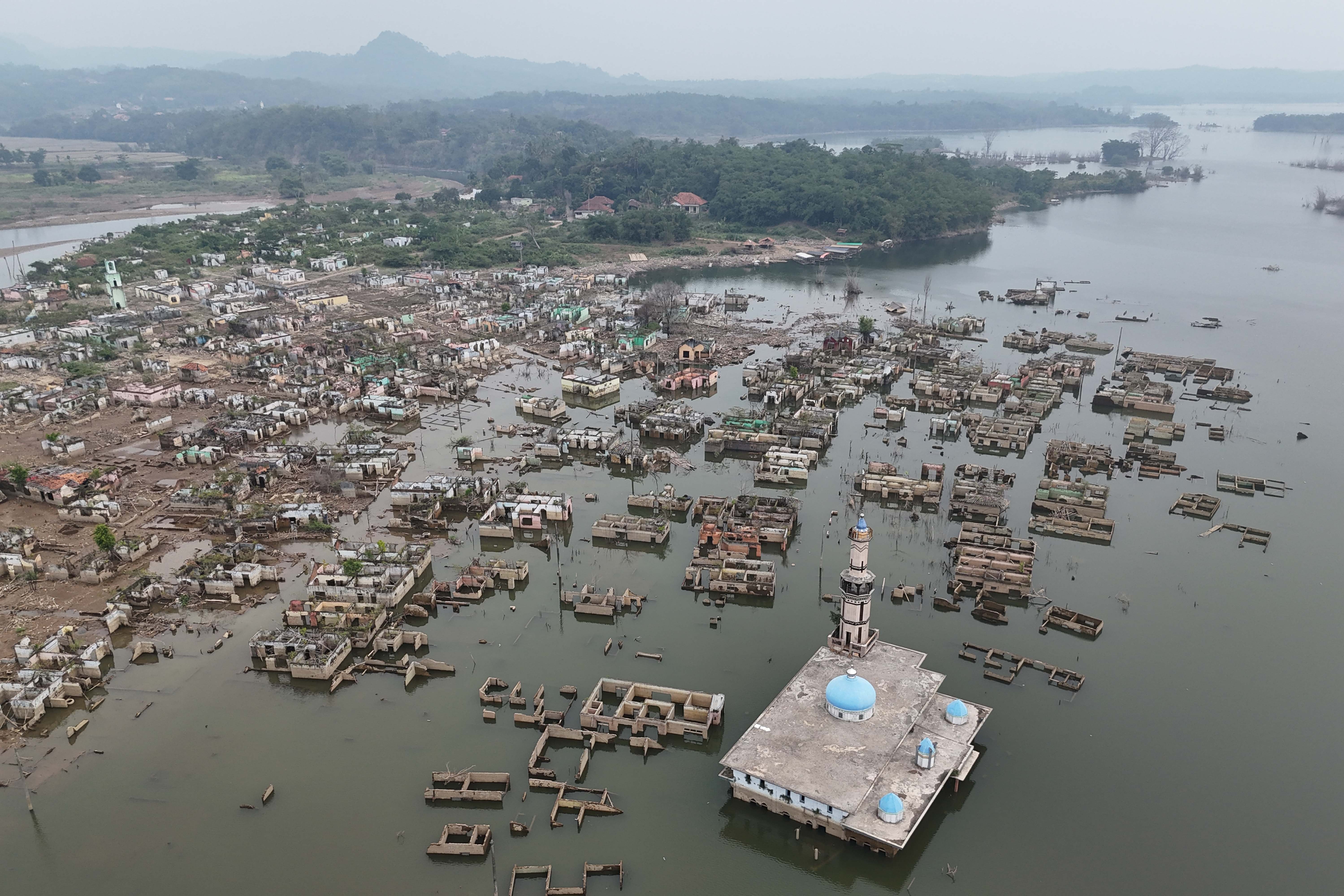 Foto udara bekas bangunan rumah yang sebelumnya tenggelam air kini muncul saat Waduk Karian mengering di Lebak, Banten, Jumat (31/7/2026). Berdasarkan keterangan warga setempat musim kemarau yang terjadi dalam satu bulan tekakhir membuat debit air di waduk tersebut mulai menyusut.