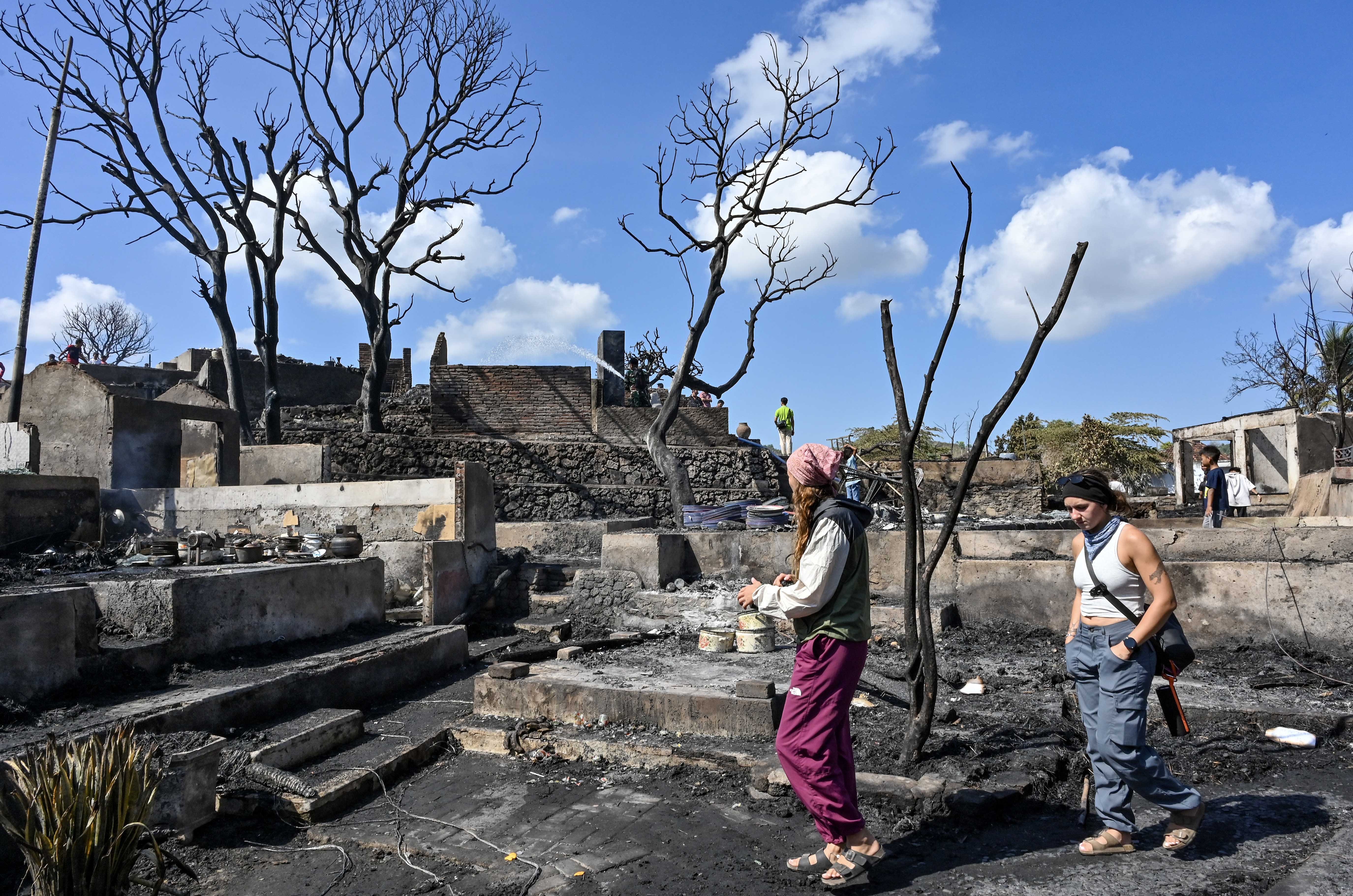 Sejumlah wisatawan asing melihat suasana pascakebakaran di Desa Adat Sade, Rembitan, Kecamatan Pujut, Praya, Lombok Tengah, NTB, Minggu (23/8/2026). Kebakaran yang terjadi sekitar pukul 20.00 Wita Minggu (22/8) menghanguskan 120 bangunan di Desa Adat Sade yang sebagian besar menggunakan material kayu, bambu, bedek serta beratap ilalang dan tidak ada korban jiwa dalam peristiwa tersebut. 