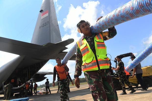 Personel menurunkan bantuan sarana dan prasarana alat pemadam api dari pesawat Hercules C-130 saat tiba di Base Ops Lanud Dhomber Balikpapan, Kalimantan Timur, Rabu (26/8/2026). Kementerian Pertahanan dan Kementerian Pertanian menyalurkan bantuan 100 unit pompa air dan sejumlah peralatan pendukung yang akan digunakan untuk menangani karhutla di wilayah Kaltim.