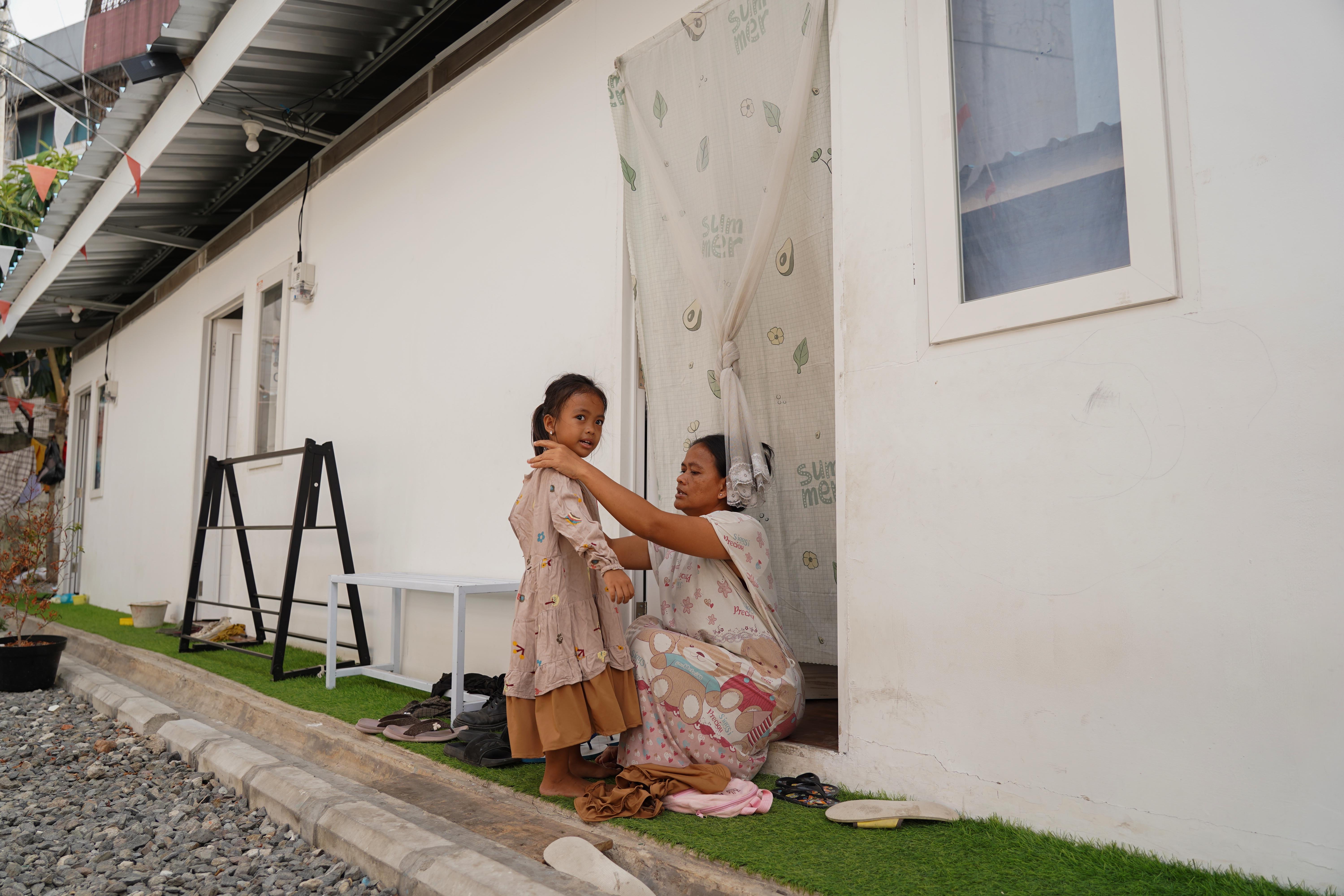 Warga bantaran rel Senen merapihkan baju anaknya di kawasan hunian layak di Kramat Raya, Senen, Jakarta Pusat, Selasa (8/9/2026). Sebanyak 275 warga yang sebelumnya tinggal di bantaran rel senen telah pindah dan menempati hunian sementara yang dibangun oleh pemerintah.