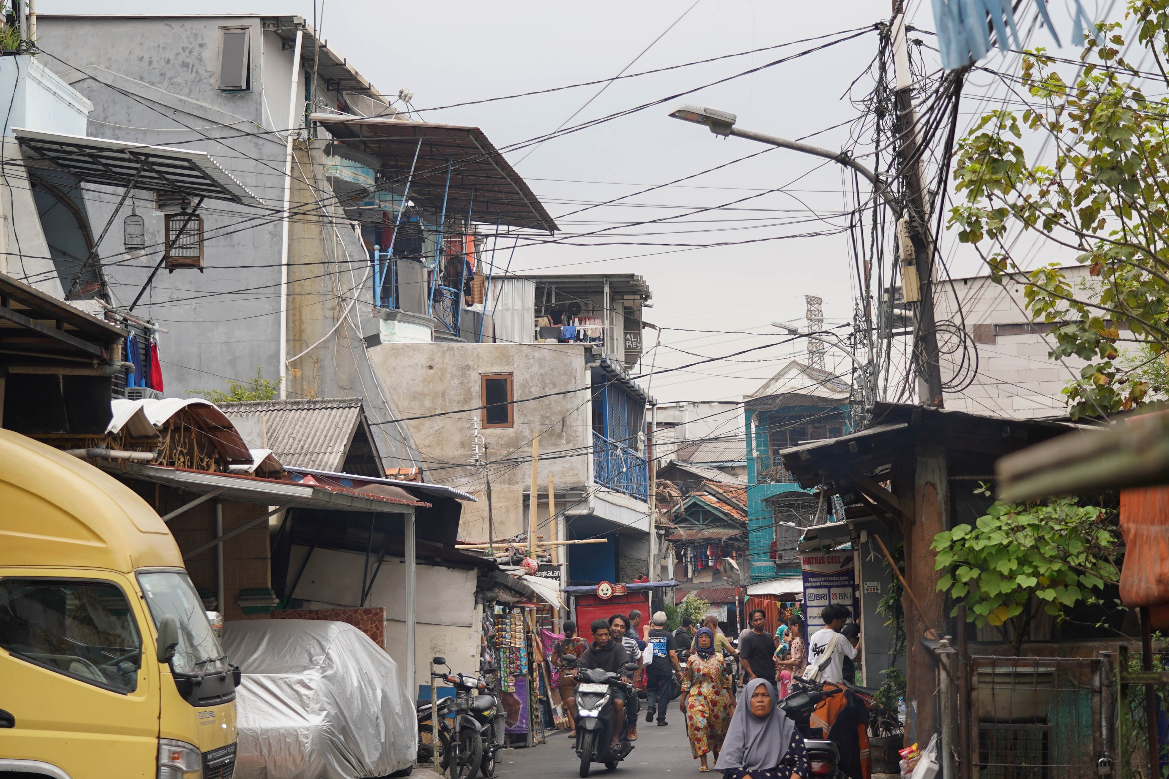Warga melintas di dekat kabel yang semrawut di kawasan Jalan Lontar Raya, Kebon Kacang, Tanah Abang, Jakarta Pusat, Rabu (30/9/2026). Pemerintah Provinsi DKI Jakarta menargetkan seluruh kabel udara di Ibu Kota dapat diturunkan ke bawah tanah dalam lima tahun ke depan sebagai upaya memperbaiki wajah kota agar lebih rapi, aman dan nyaman bagi masyarakat.
